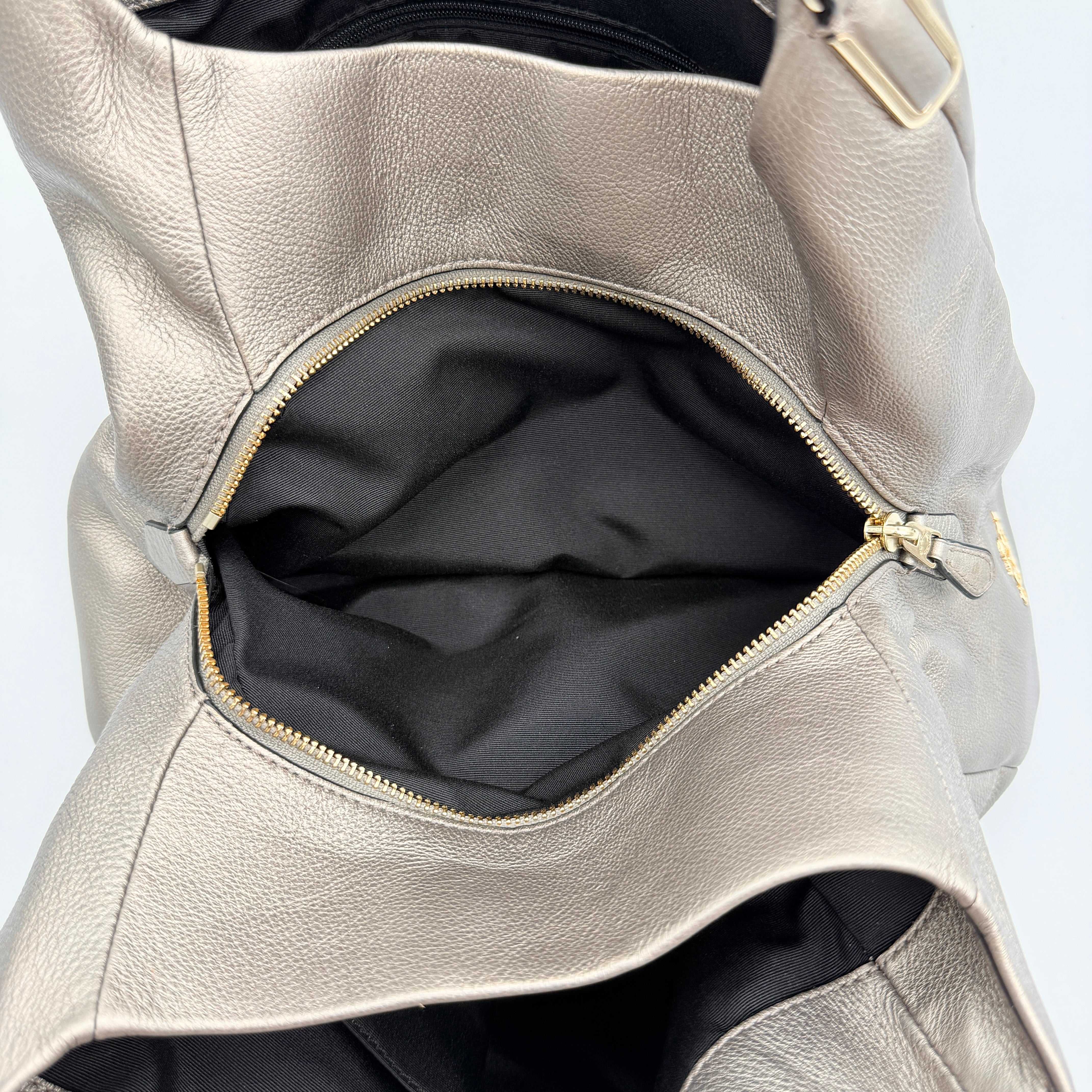 Coach Madison Phoebe shoulder bag in metallic taupe pebbled leather with dual straps and gold-tone hardware.