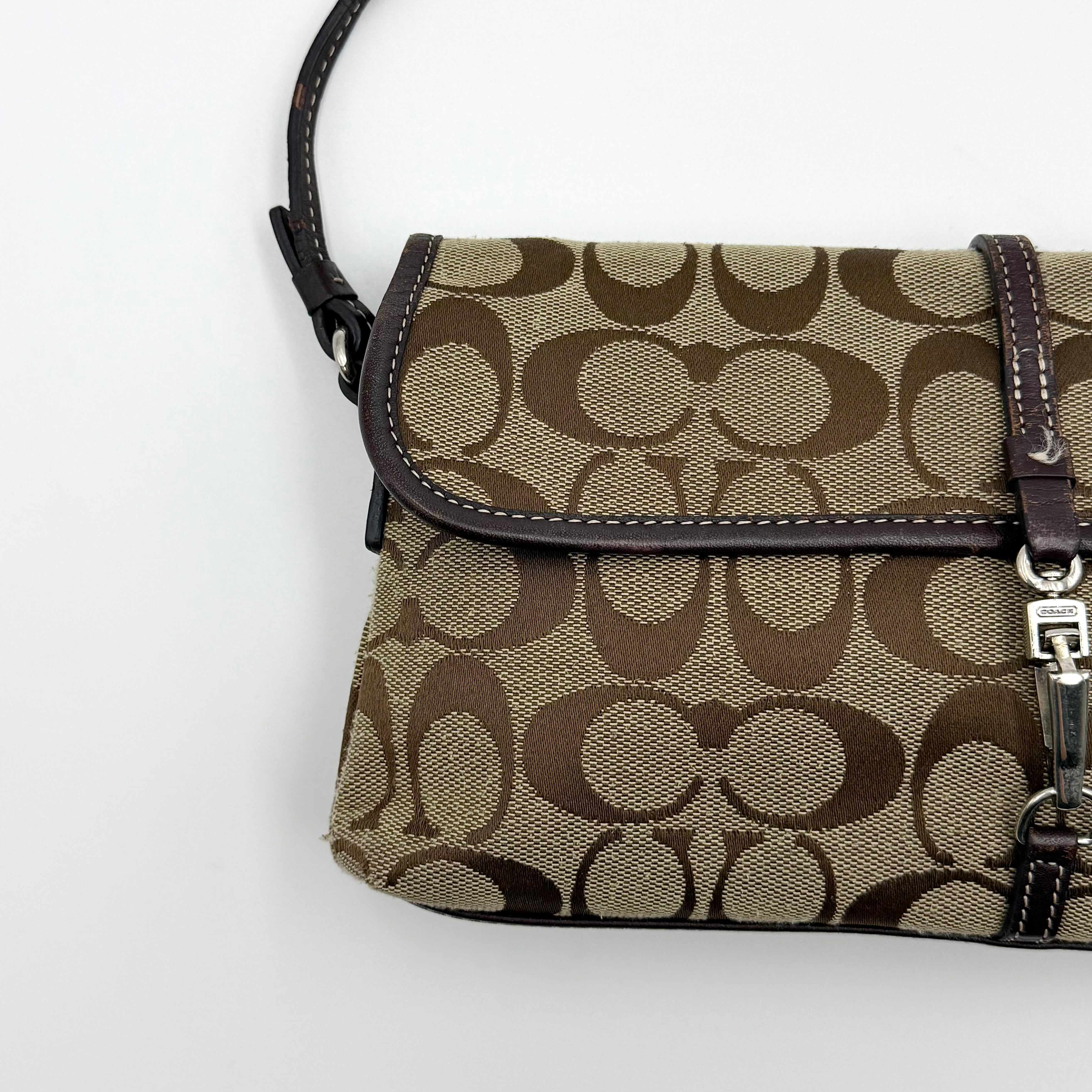Coach Y2K Demi Clip Baguette in beige and brown canvas with leather trim, featuring signature monogram and shoulder strap.