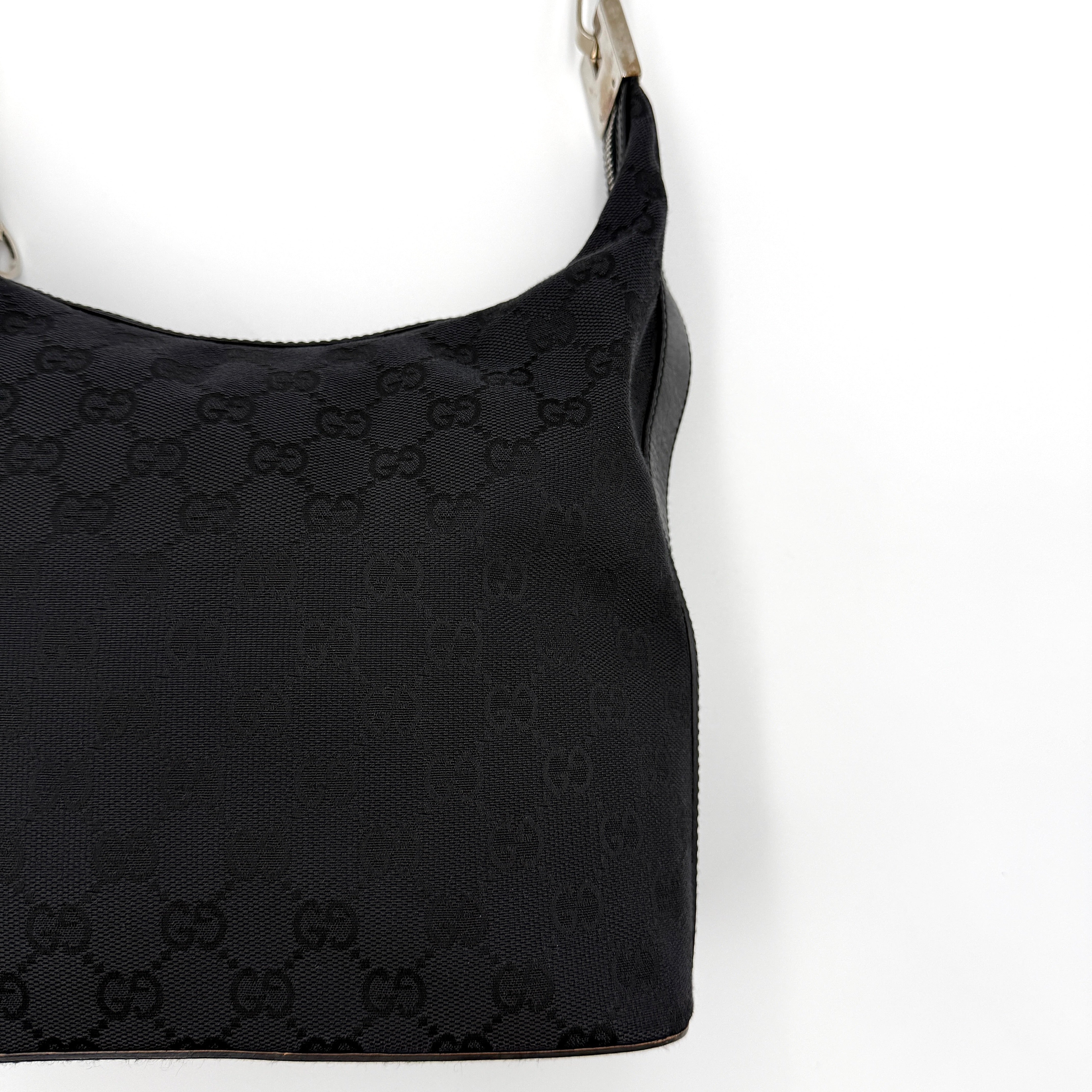 Gucci GG Monogram Hobo Shoulder Bag in black canvas with tonal GG logo pattern, silver-tone hardware and a single top handle.