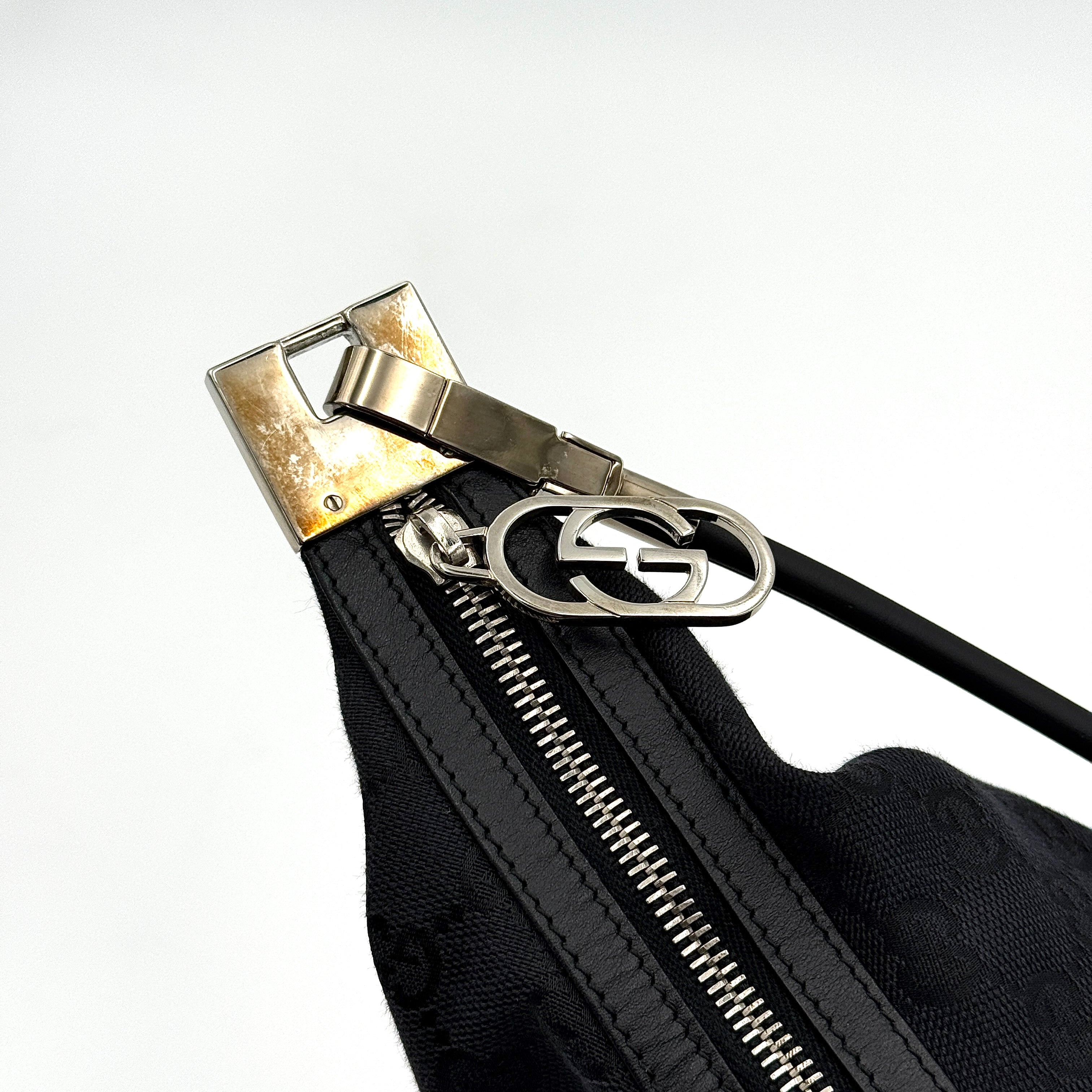 Gucci GG Monogram Hobo Shoulder Bag in black canvas with tonal GG logo pattern, silver-tone hardware and a single top handle.