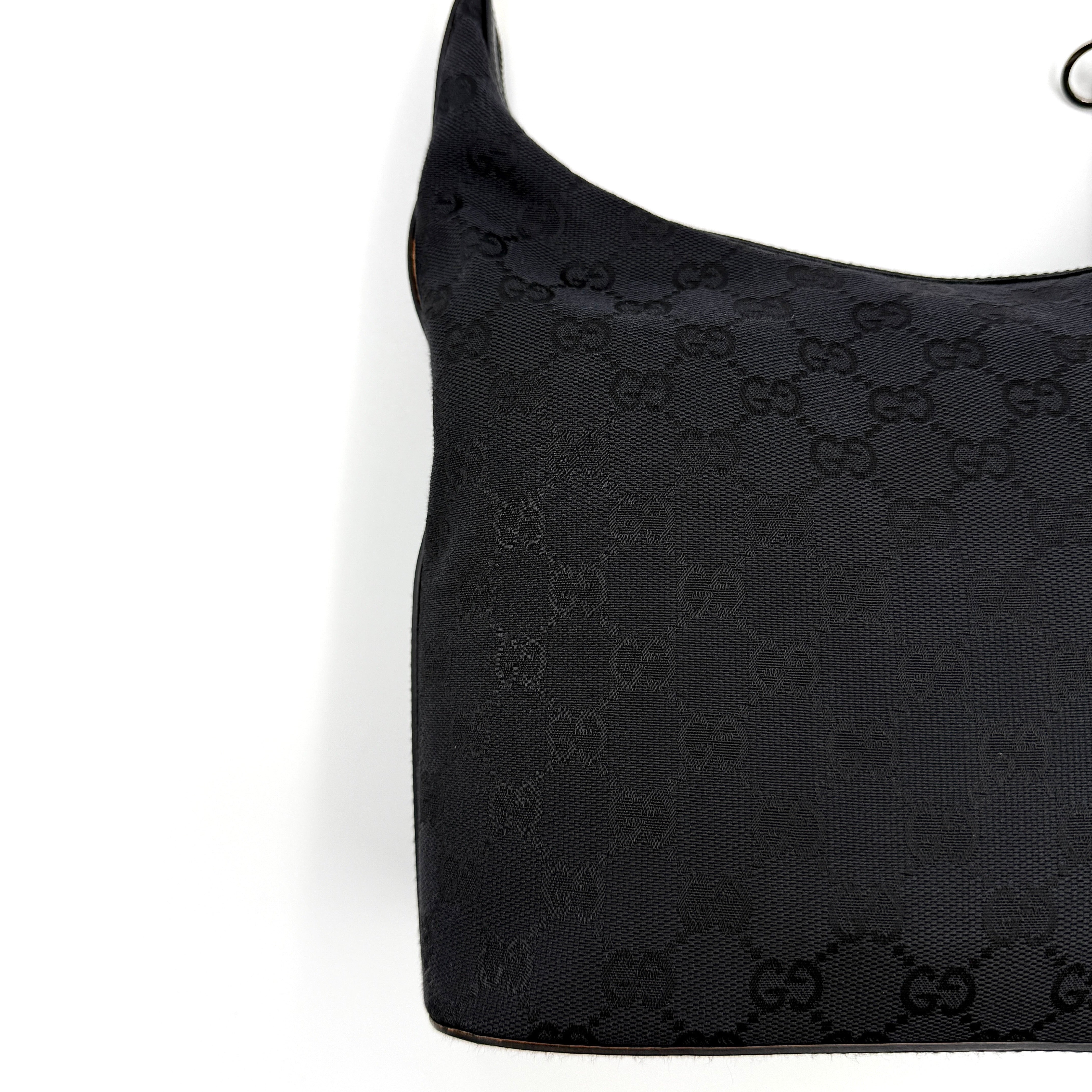 Gucci GG Monogram Hobo Shoulder Bag in black canvas with tonal GG logo pattern, silver-tone hardware and a single top handle.