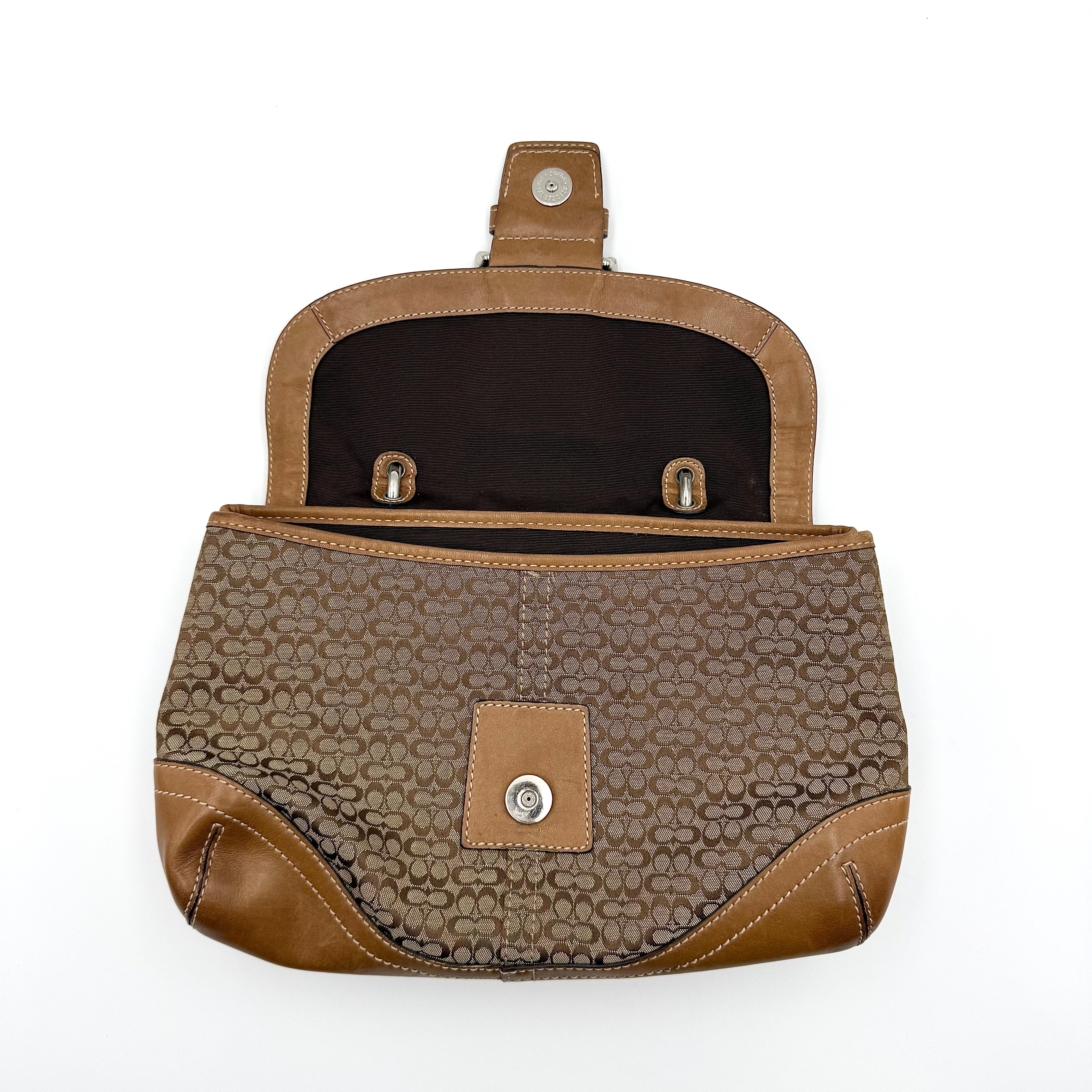 Coach Signature Soho shoulder bag in beige and tan jacquard with leather trim and silver D-ring buckle, shown against a white background.