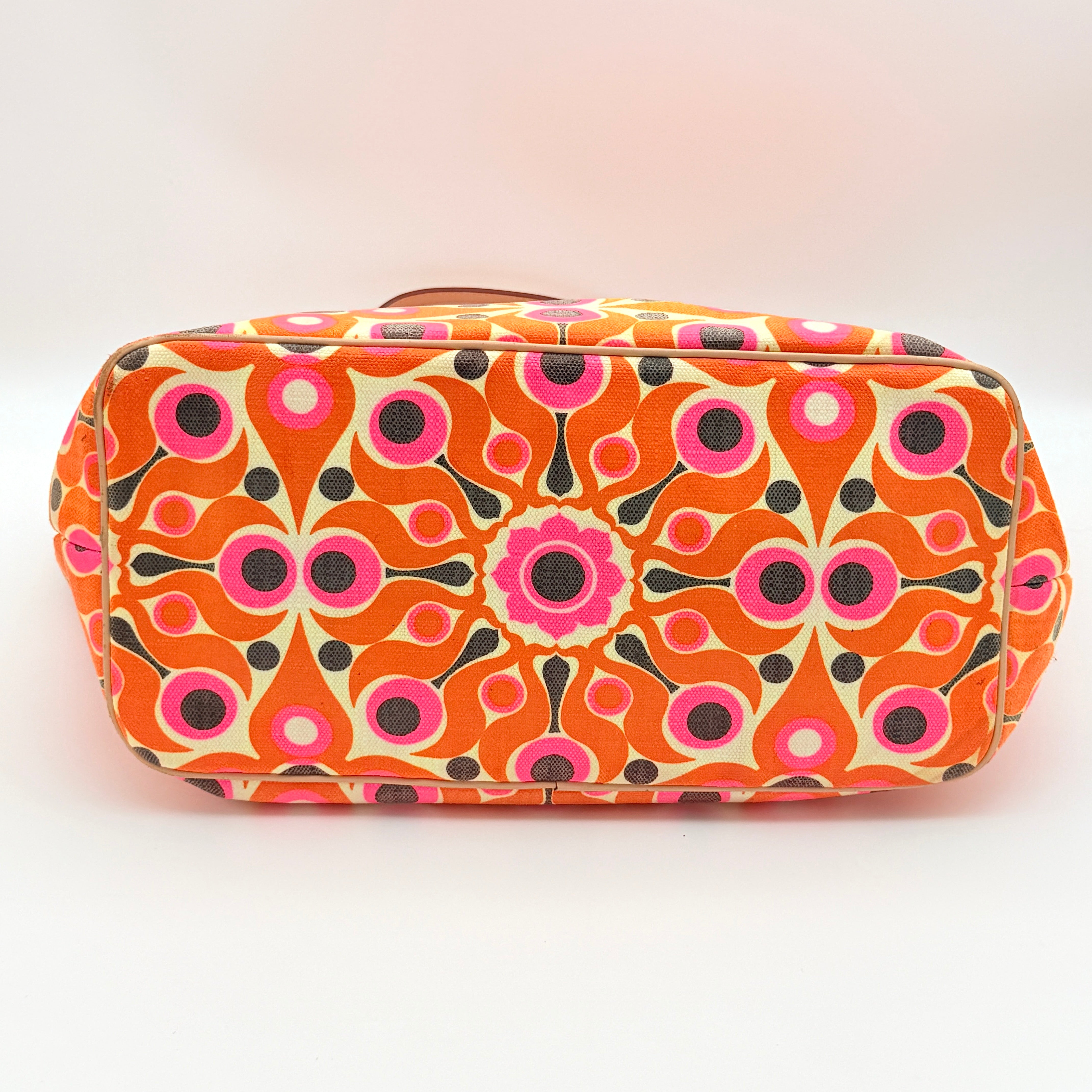 Kate Spade New York tote bag in a bold multicolour geometric pattern with beige leather handles, displayed upright against a white background.