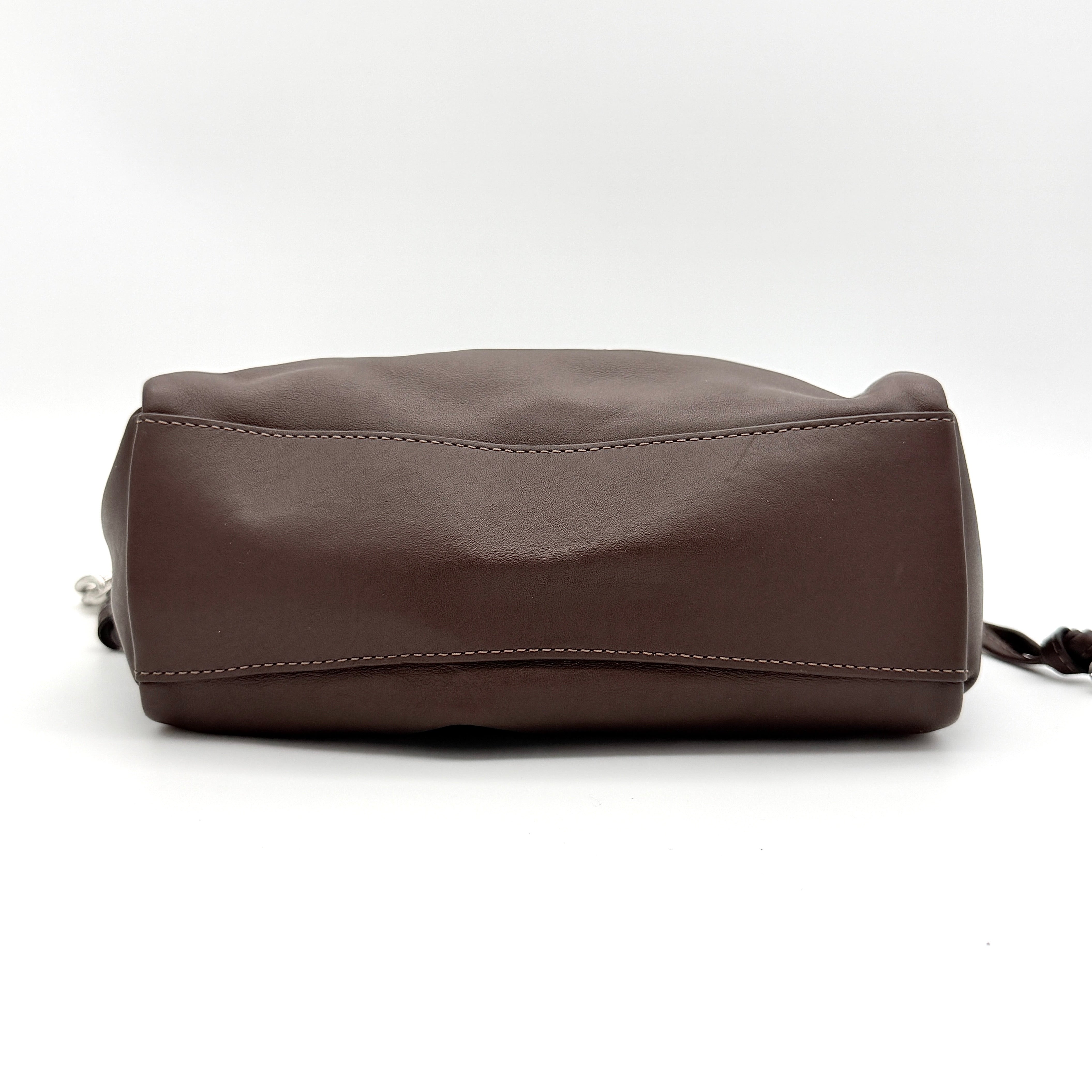 Coach Faye shoulder bag in brown leather with chunky silver-tone chain handle and detachable strap, displayed against a white background.