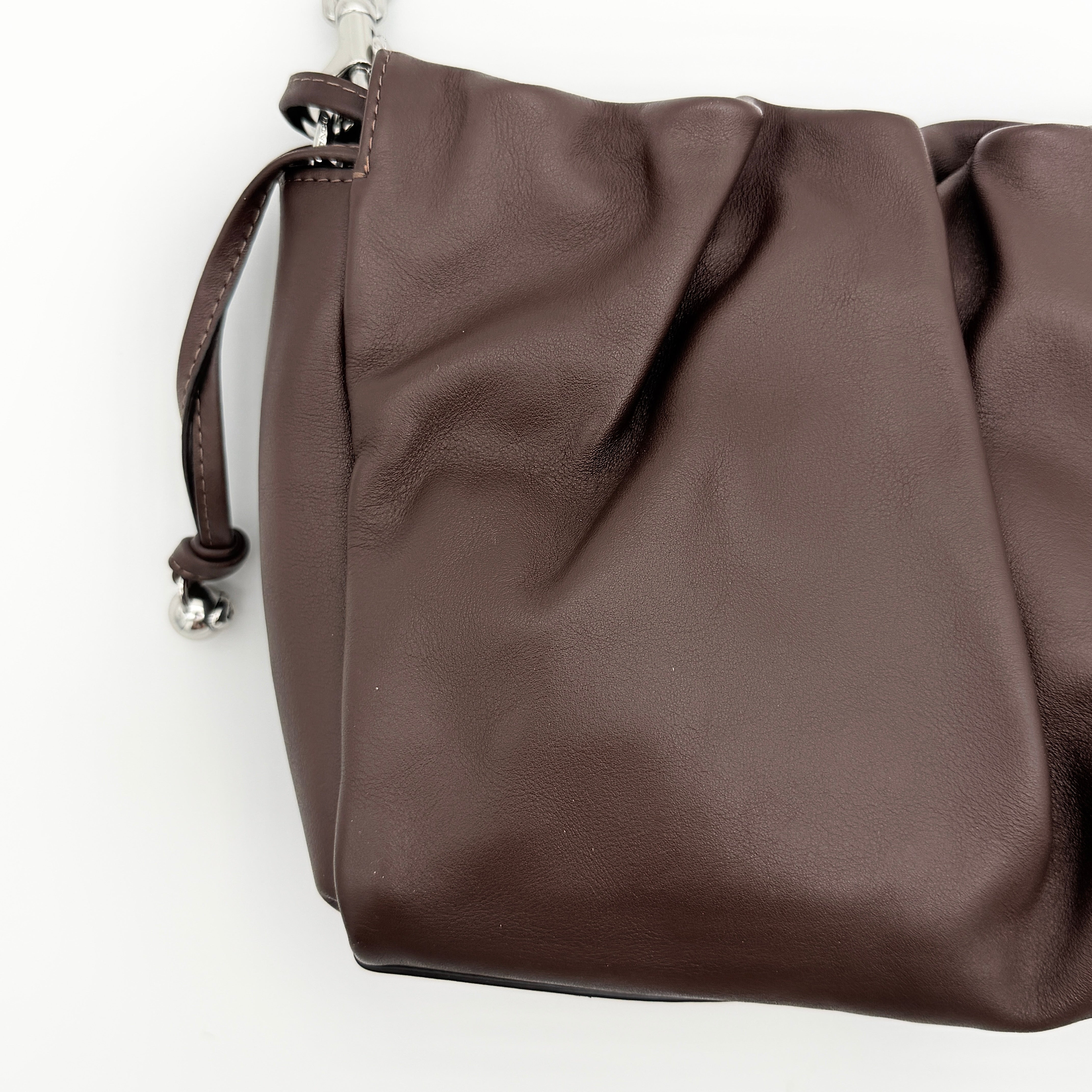 Coach Faye shoulder bag in brown leather with chunky silver-tone chain handle and detachable strap, displayed against a white background.