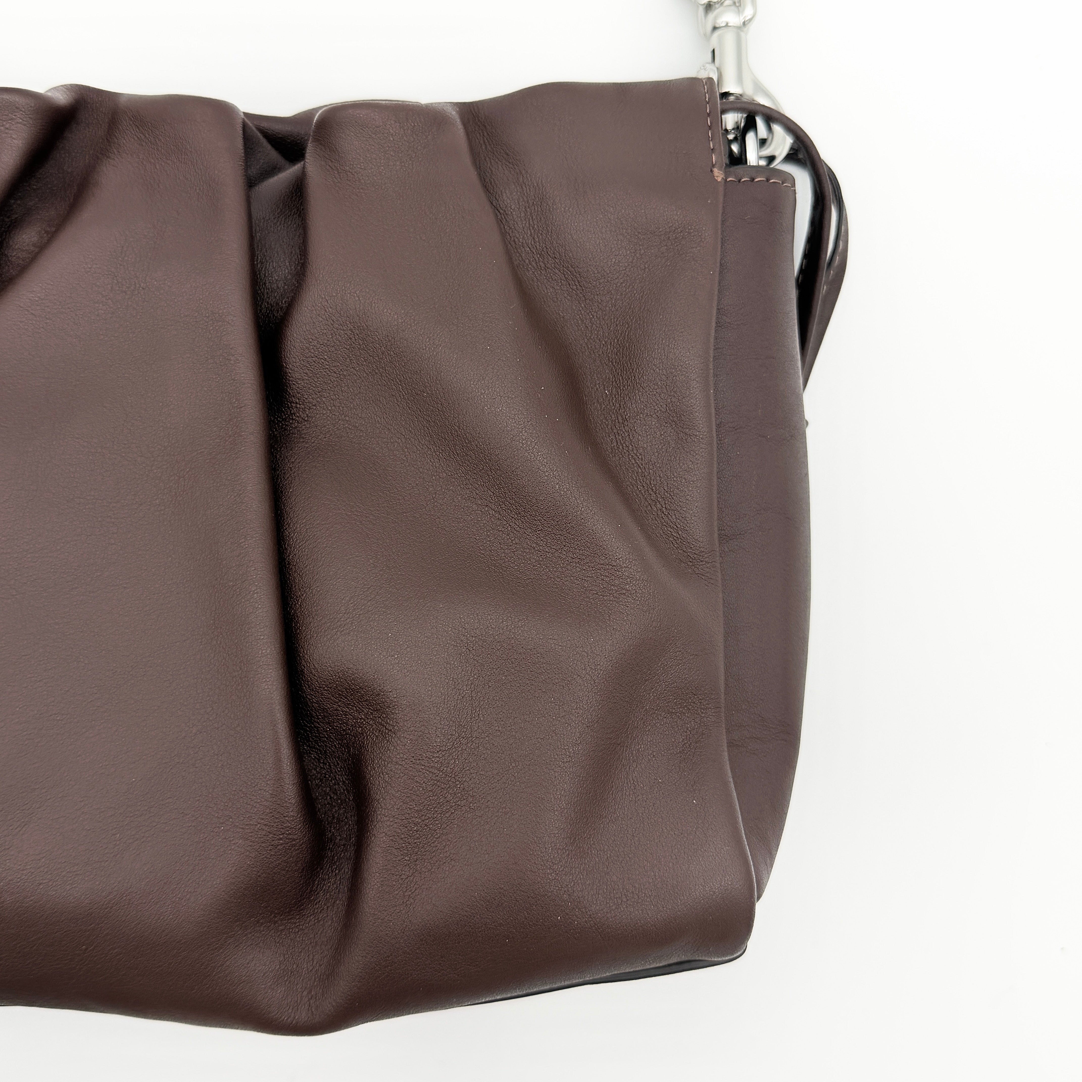 Coach Faye shoulder bag in brown leather with chunky silver-tone chain handle and detachable strap, displayed against a white background.