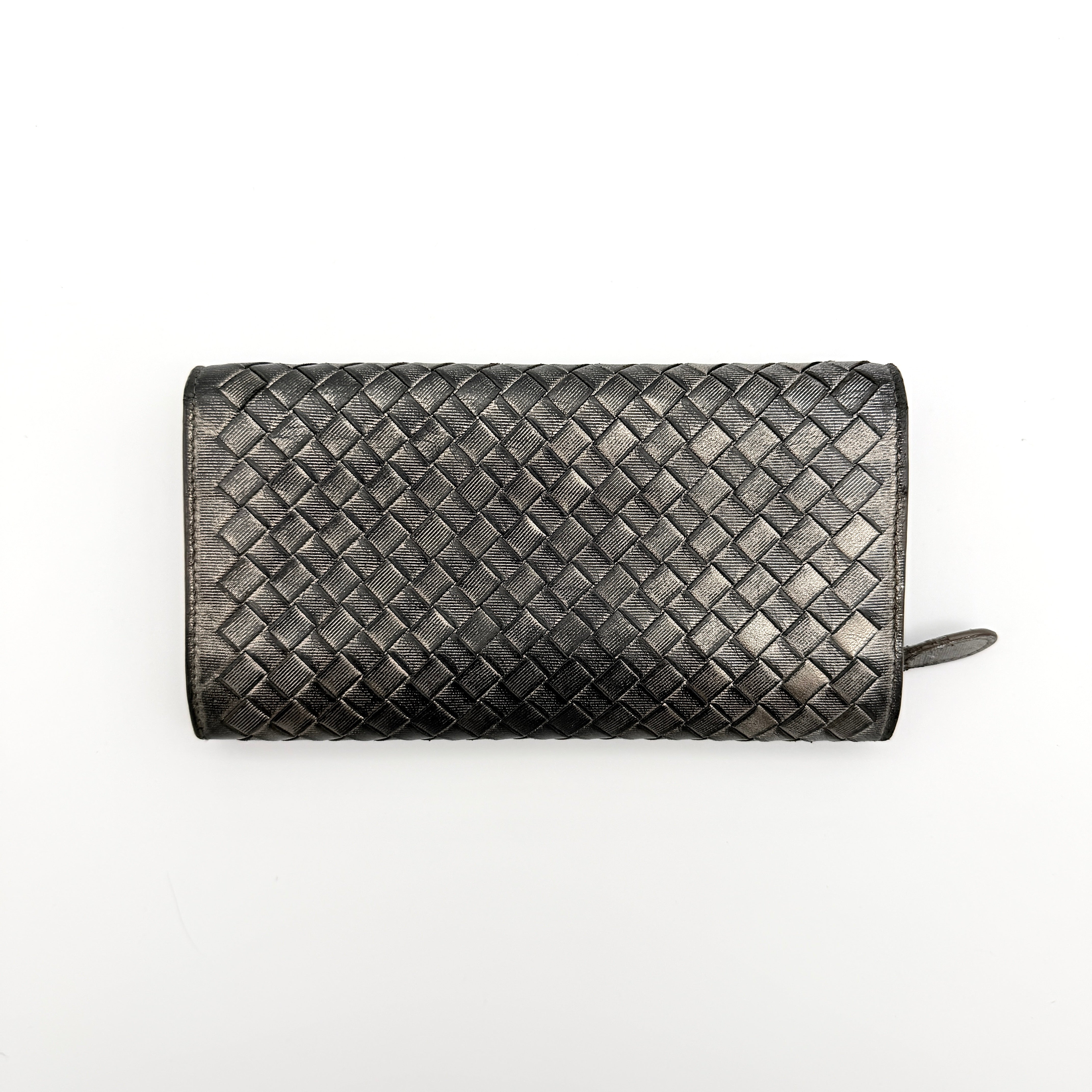 Bottega Veneta Intrecciato Flap Continental Long Wallet in metallic grey with woven leather finish, shown closed on a white background.
