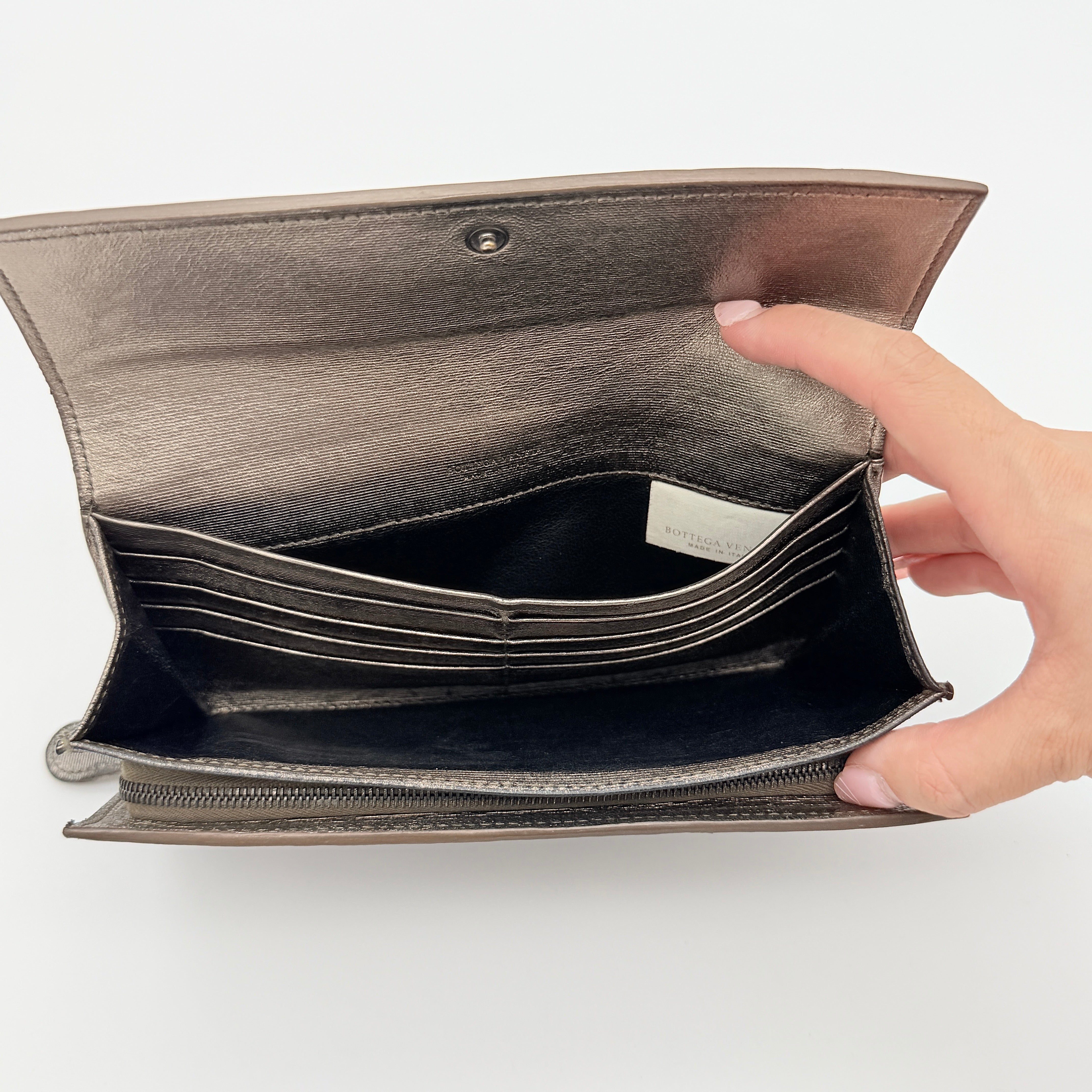 Bottega Veneta Intrecciato Flap Continental Long Wallet in metallic grey with woven leather finish, shown closed on a white background.
