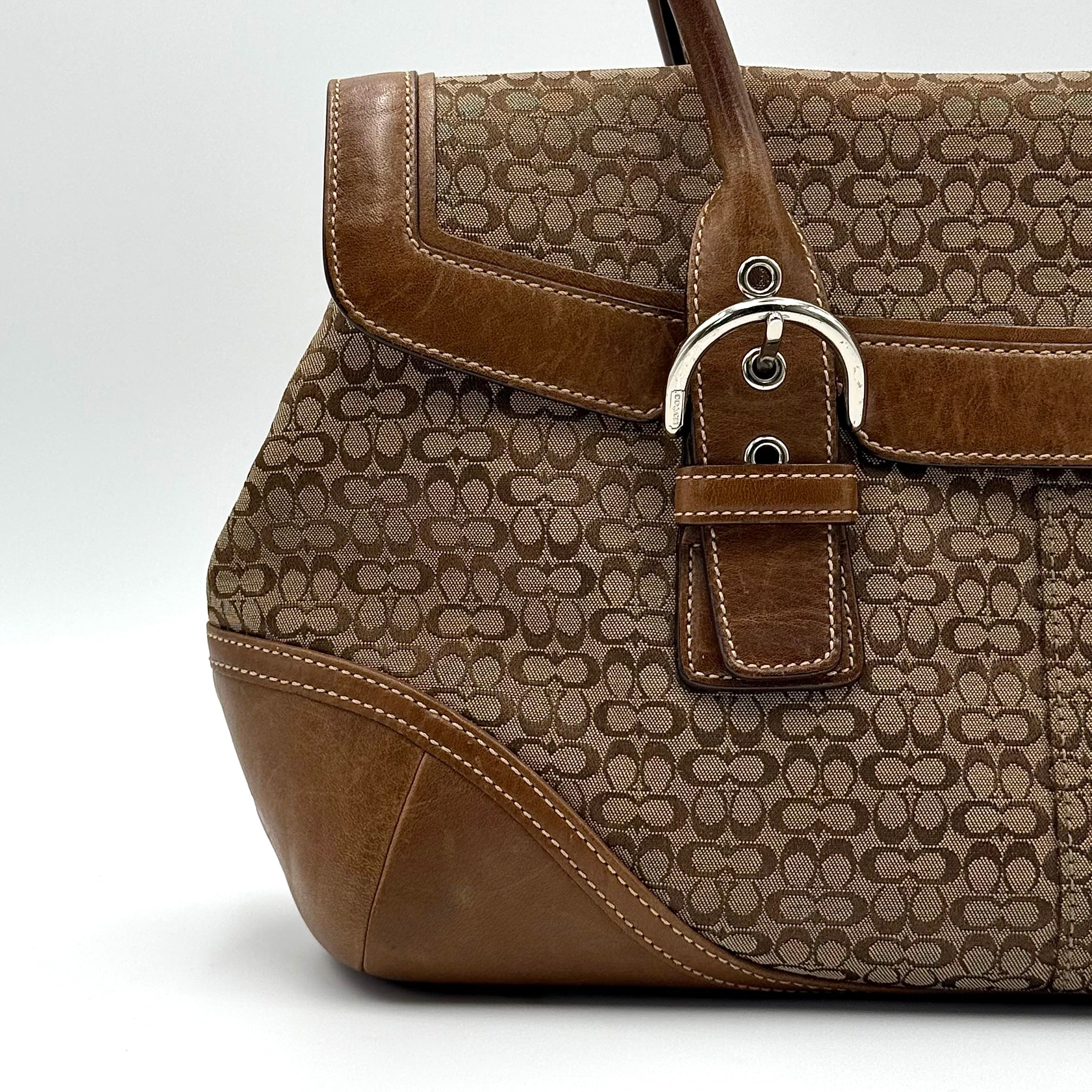 Coach Soho Hampton satchel in beige jacquard canvas with tan leather trim and rolled handles shown against a white background.