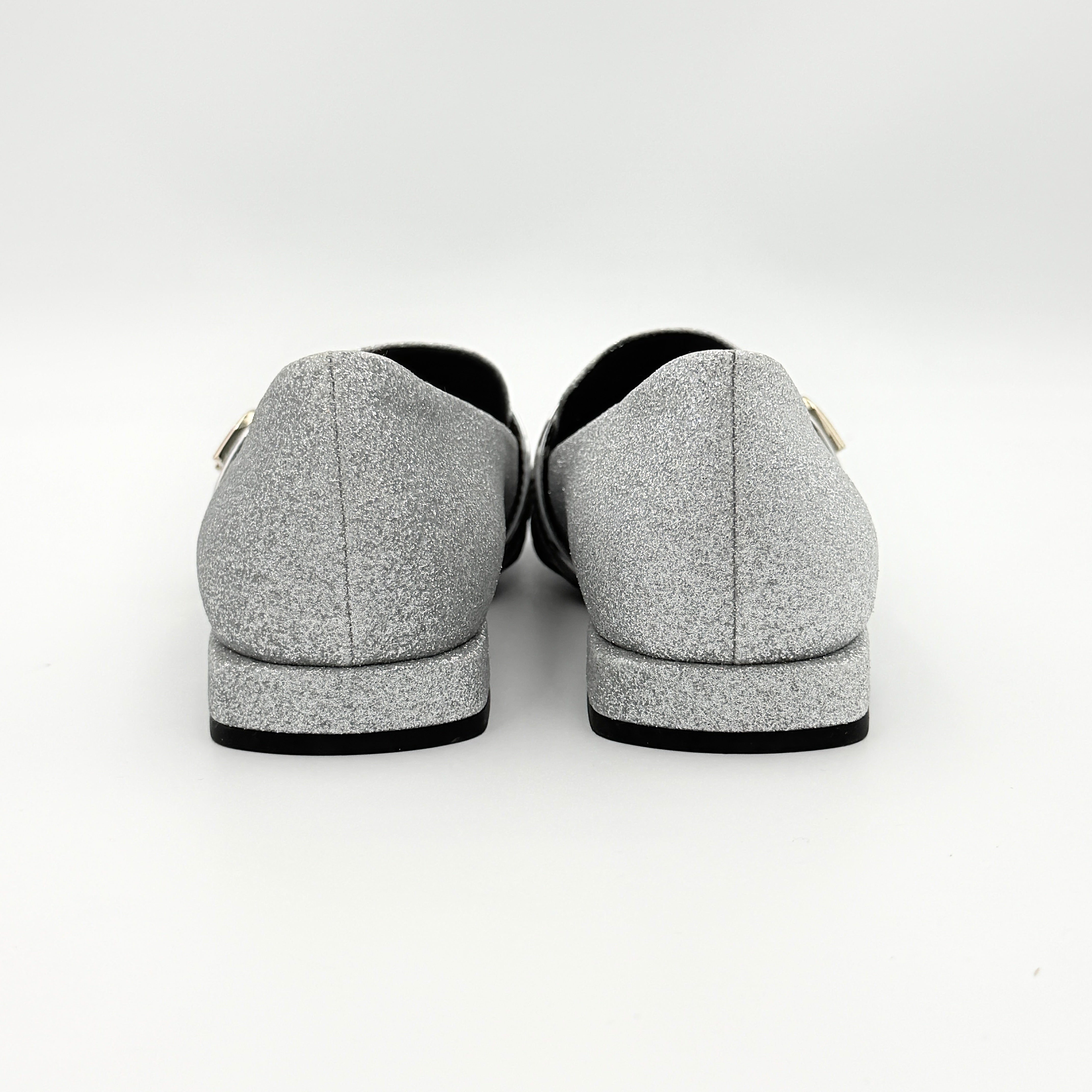 Furla 1927 T.20 loafers in silver microglitter with metallic strap and gold-tone detail, displayed in a three-quarter view.