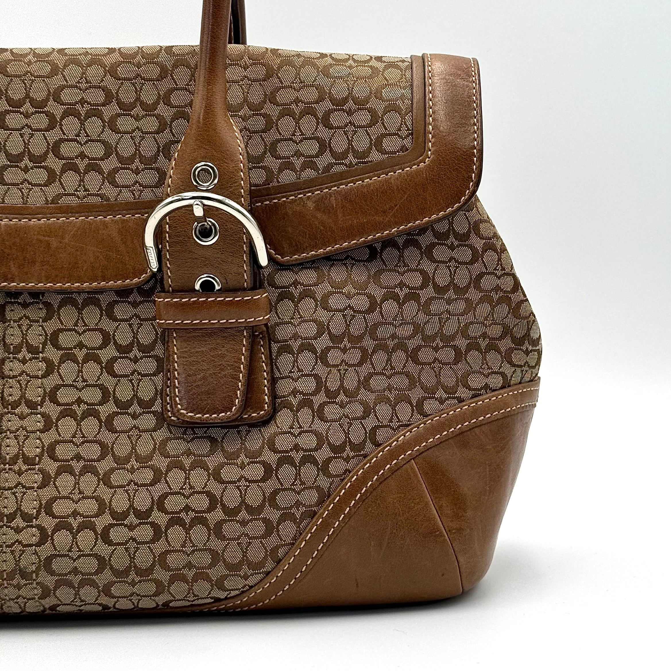 Coach Soho Hampton satchel in beige jacquard canvas with tan leather trim and rolled handles shown against a white background.