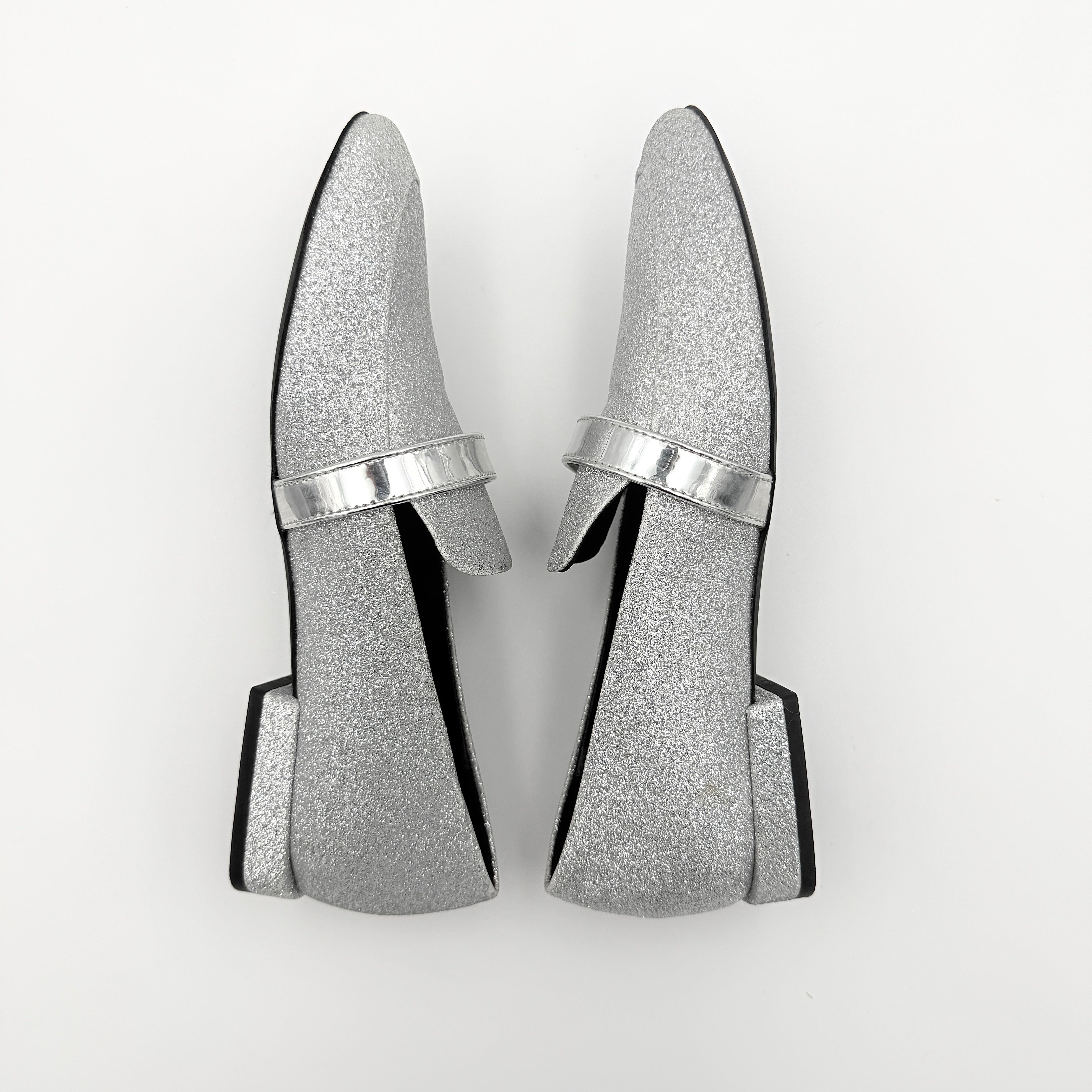 Furla 1927 T.20 loafers in silver microglitter with metallic strap and gold-tone detail, displayed in a three-quarter view.