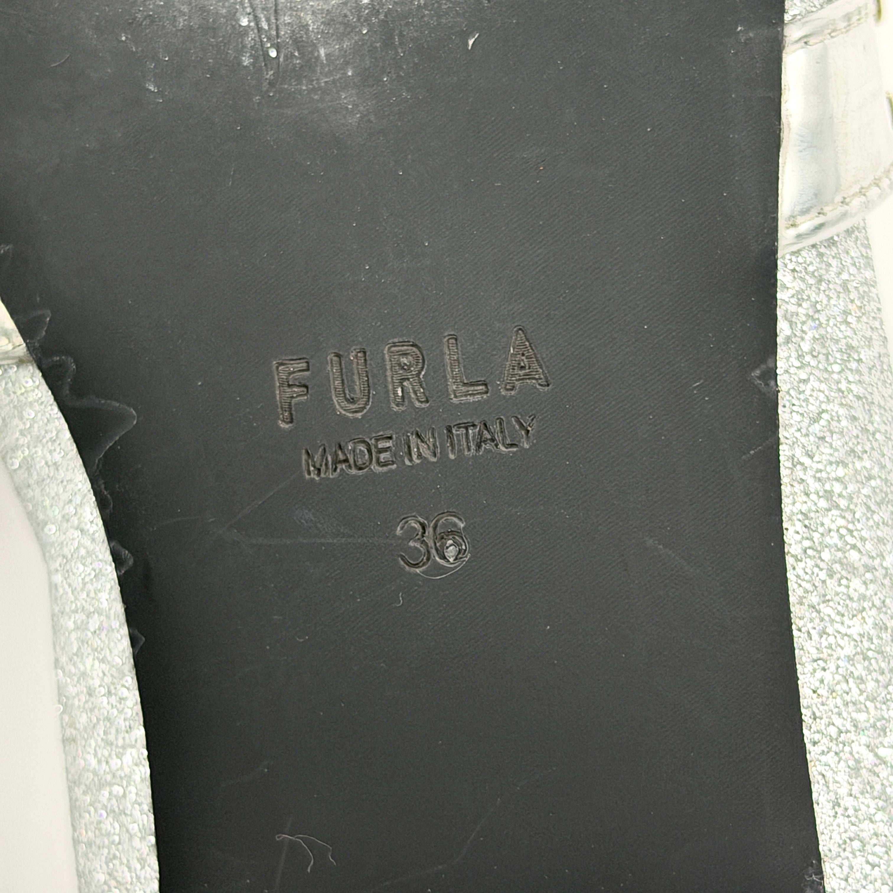 Furla 1927 T.20 loafers in silver microglitter with metallic strap and gold-tone detail, displayed in a three-quarter view.