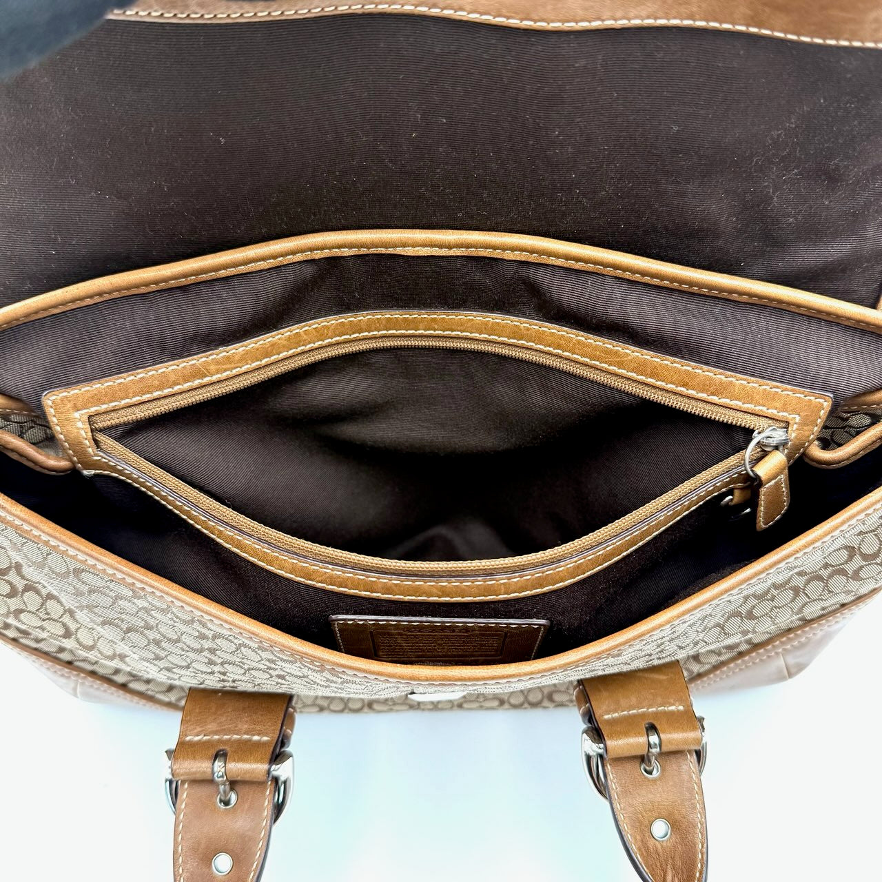 Coach Soho Hampton satchel in beige jacquard canvas with tan leather trim and rolled handles shown against a white background.