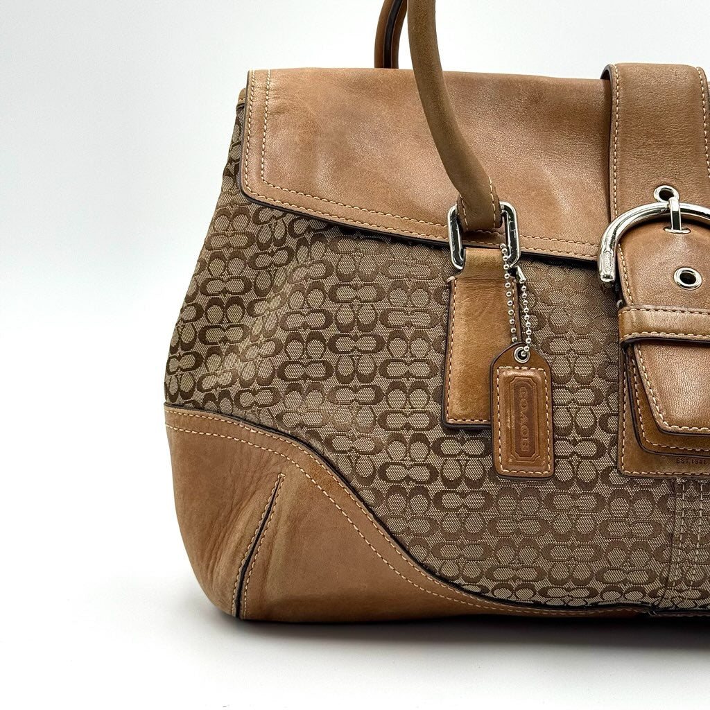 Coach Signature Soho shoulder bag in beige and tan canvas with leather trim and silver buckle.