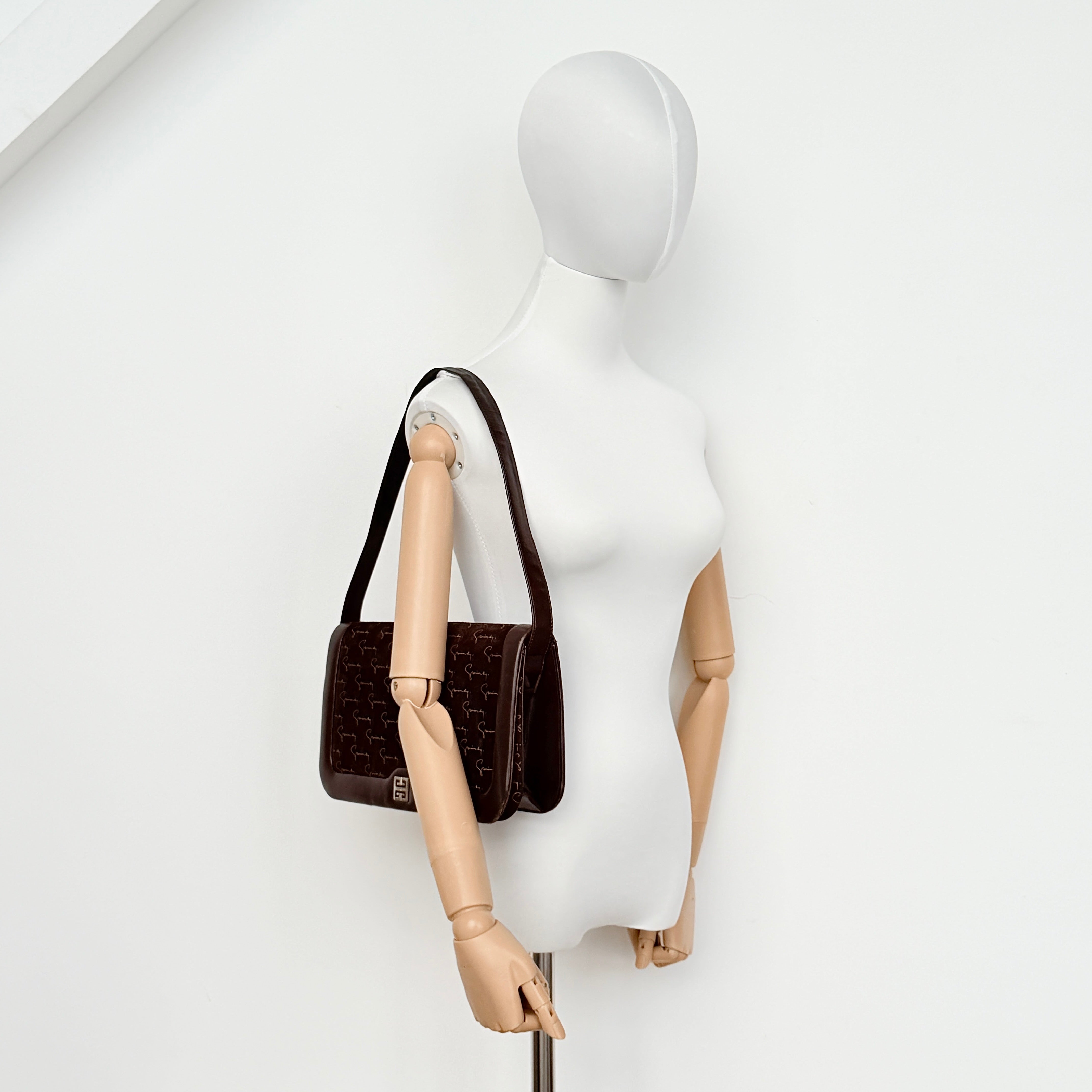 Givenchy 4G Monogram brown suede shoulder bag with leather trim and silver-tone clasp, photographed on a white background.