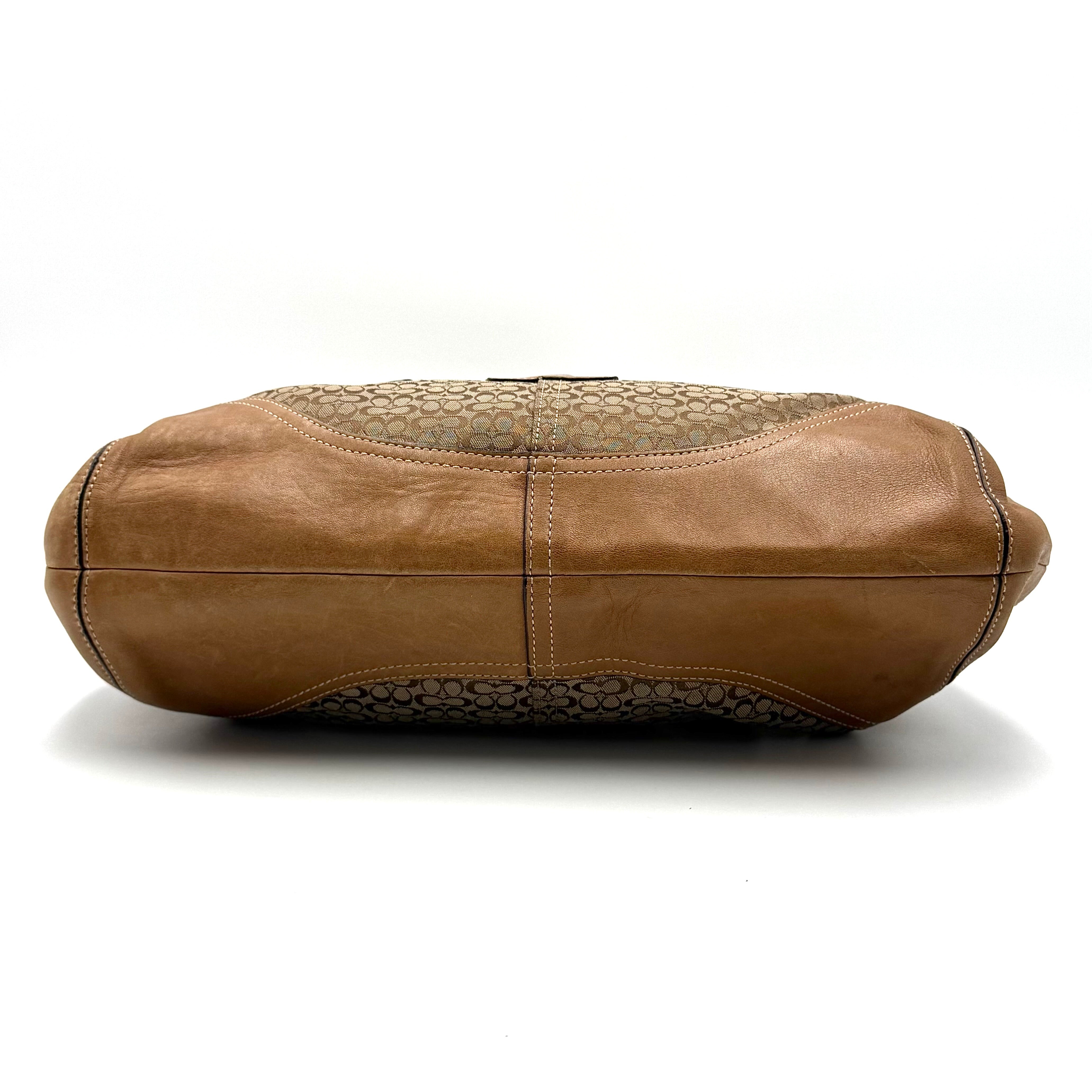 Coach Signature Soho shoulder bag in beige and tan canvas with leather trim and silver buckle.