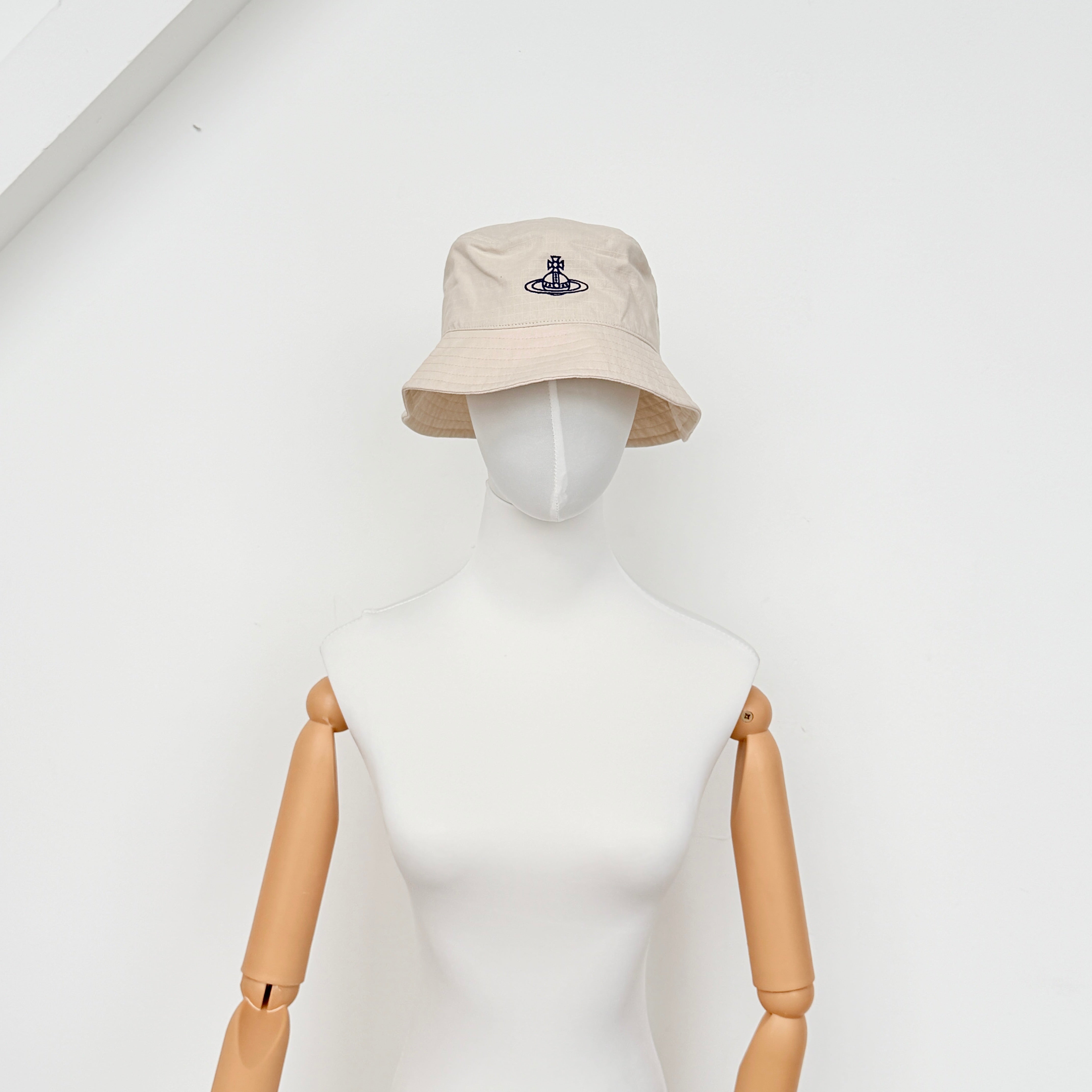 Vivienne Westwood Orb London bucket hat in cream cotton with black embroidery, shown from the front.