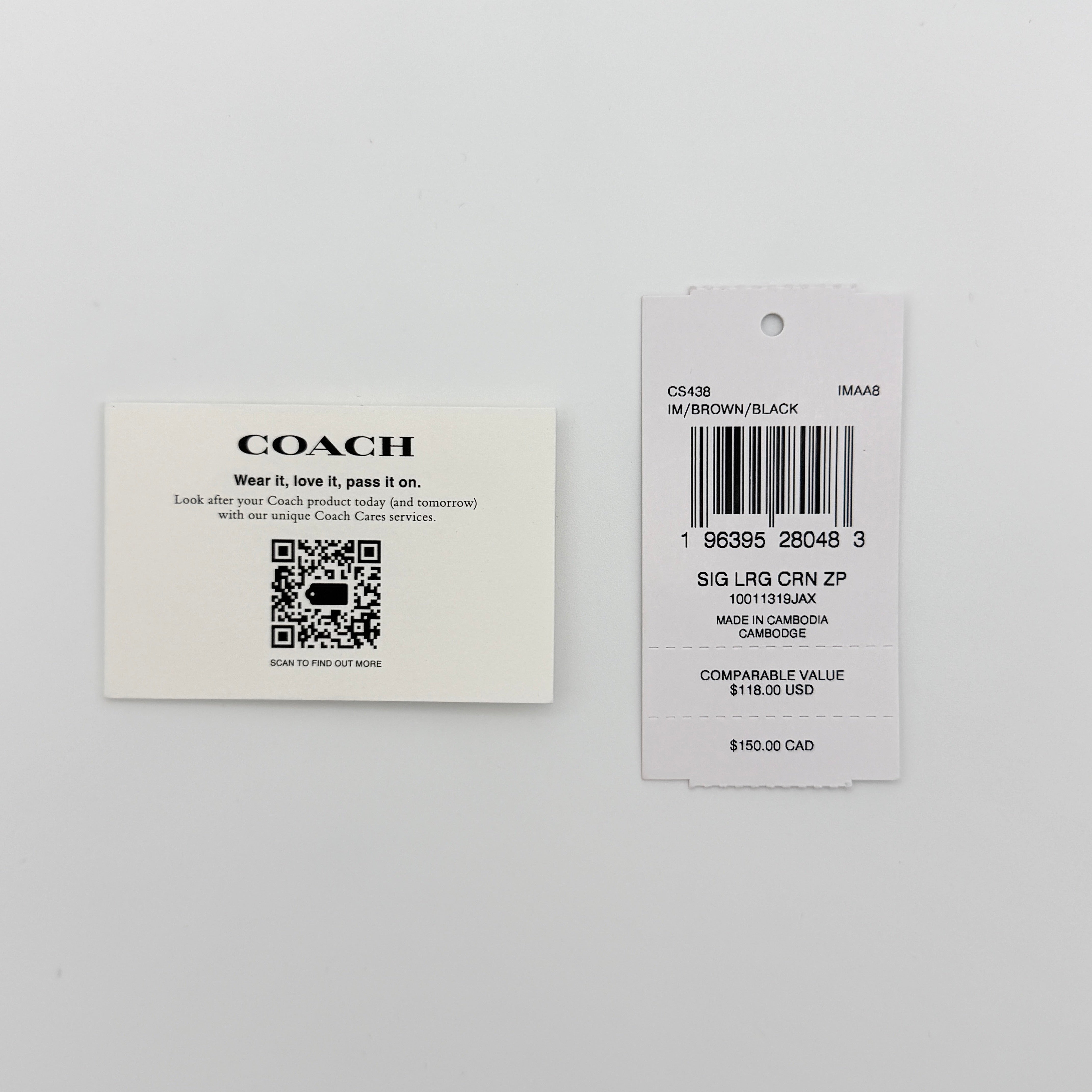 Coach Signature Large Corner Zip Wristlet in brown coated canvas with gold hardware and black wrist strap.