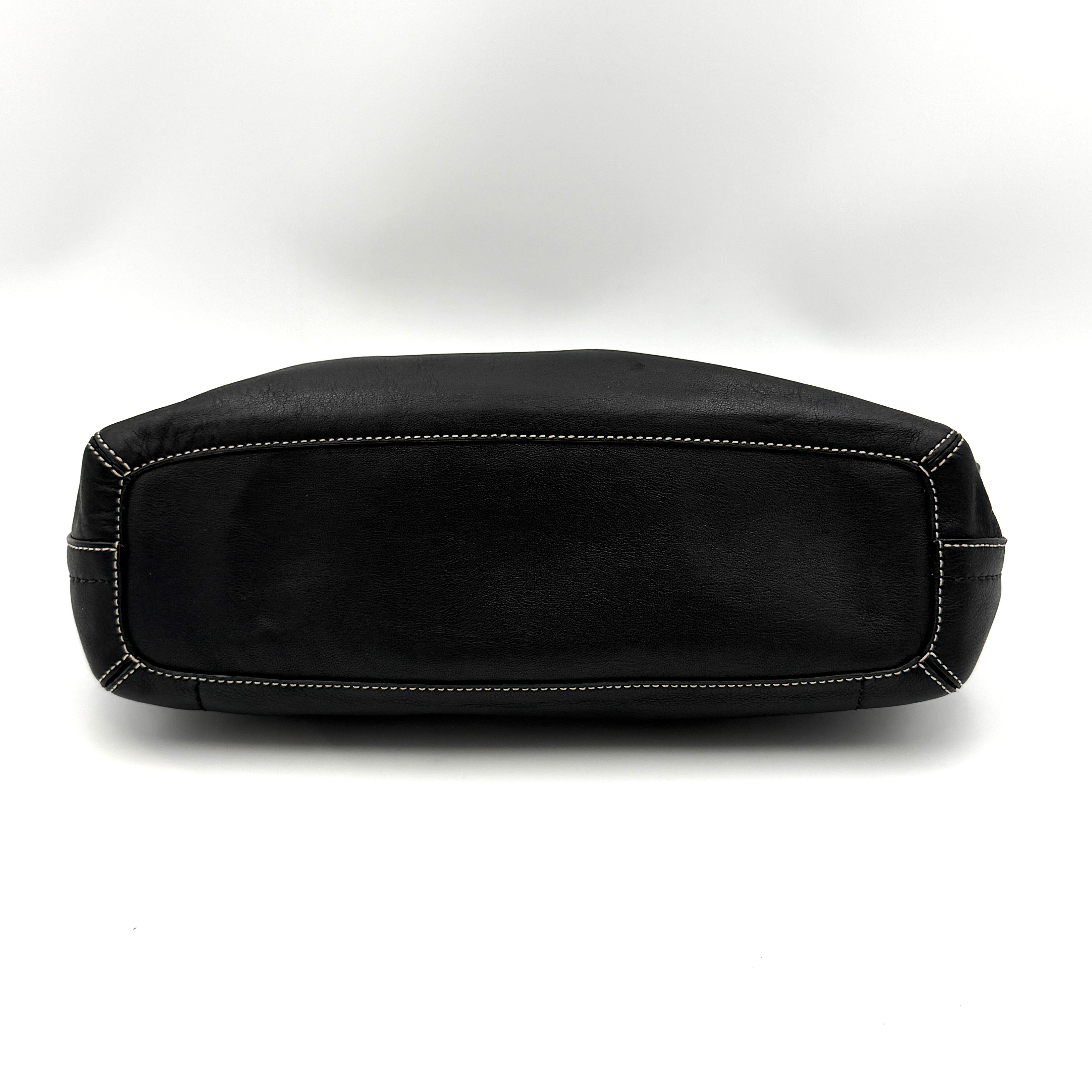 Coach Signature East West Shoulder Bag in black leather with silver hardware and contrast stitching, displayed on a white background.