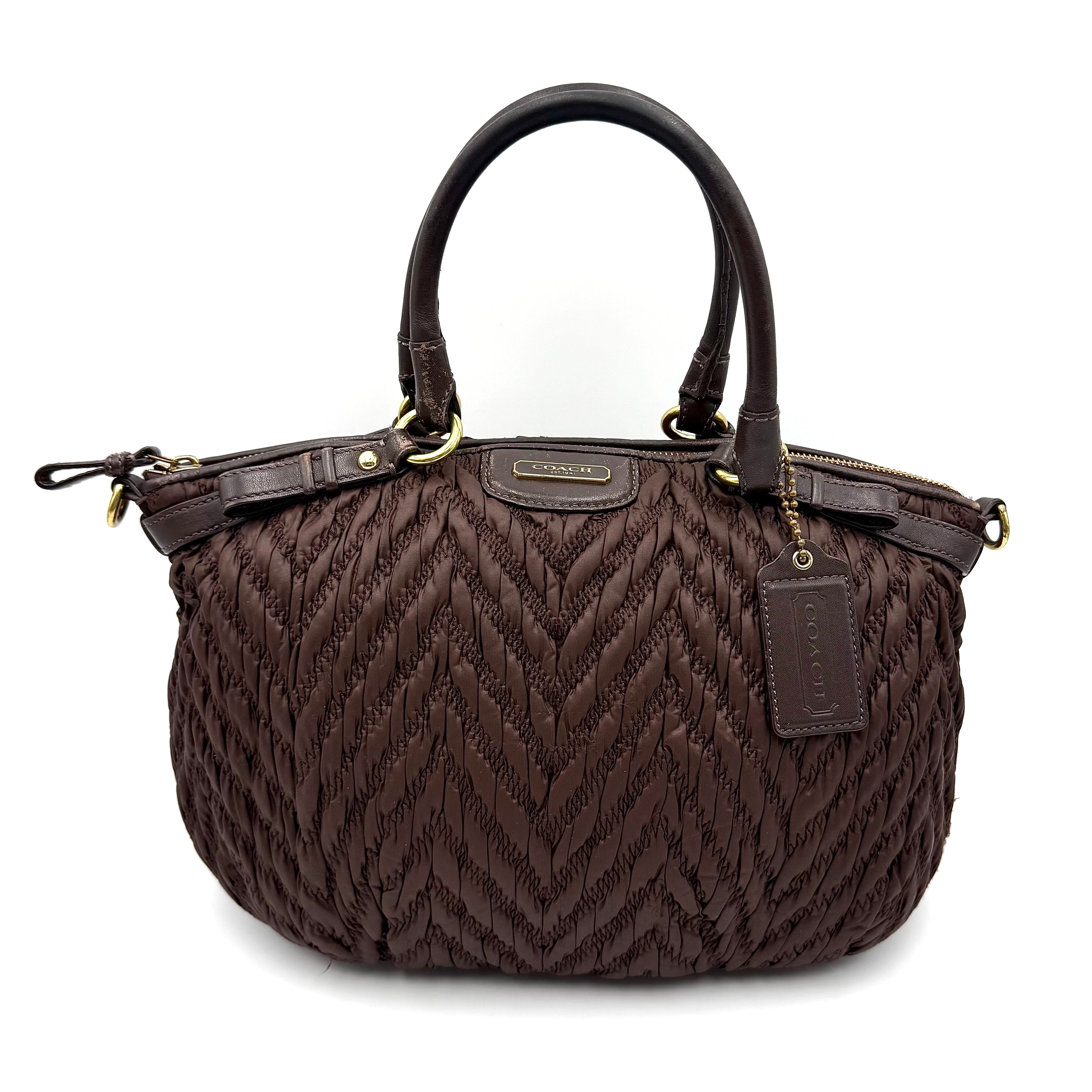 Front view of the Coach Madison Chevron 2Way brown quilted nylon shoulder bag with rolled leather handles and gold-tone hardware.