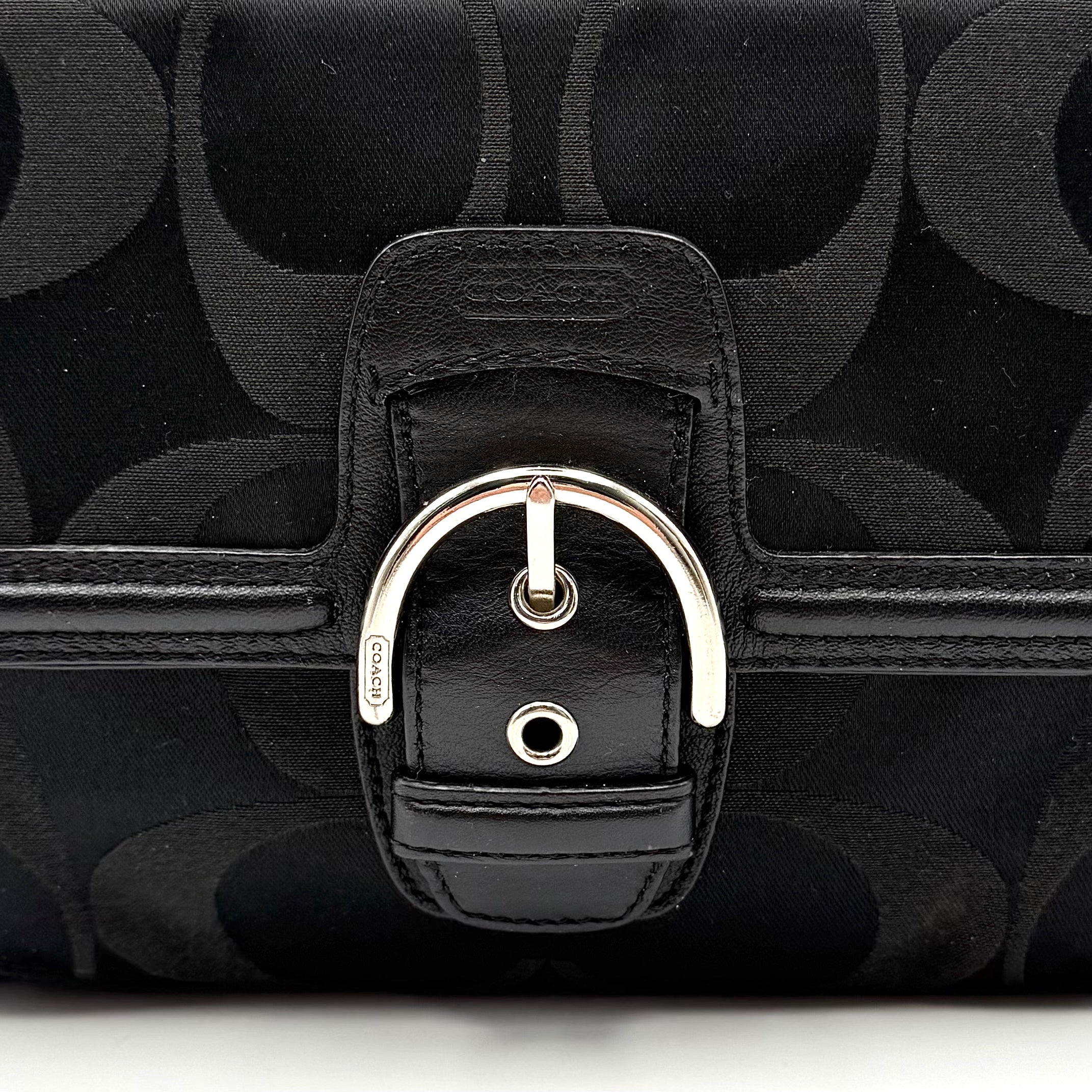 Coach Signature Campbell Hobo Shoulder Bag in black jacquard canvas with leather trim and front buckle pocket, photographed against a white background.