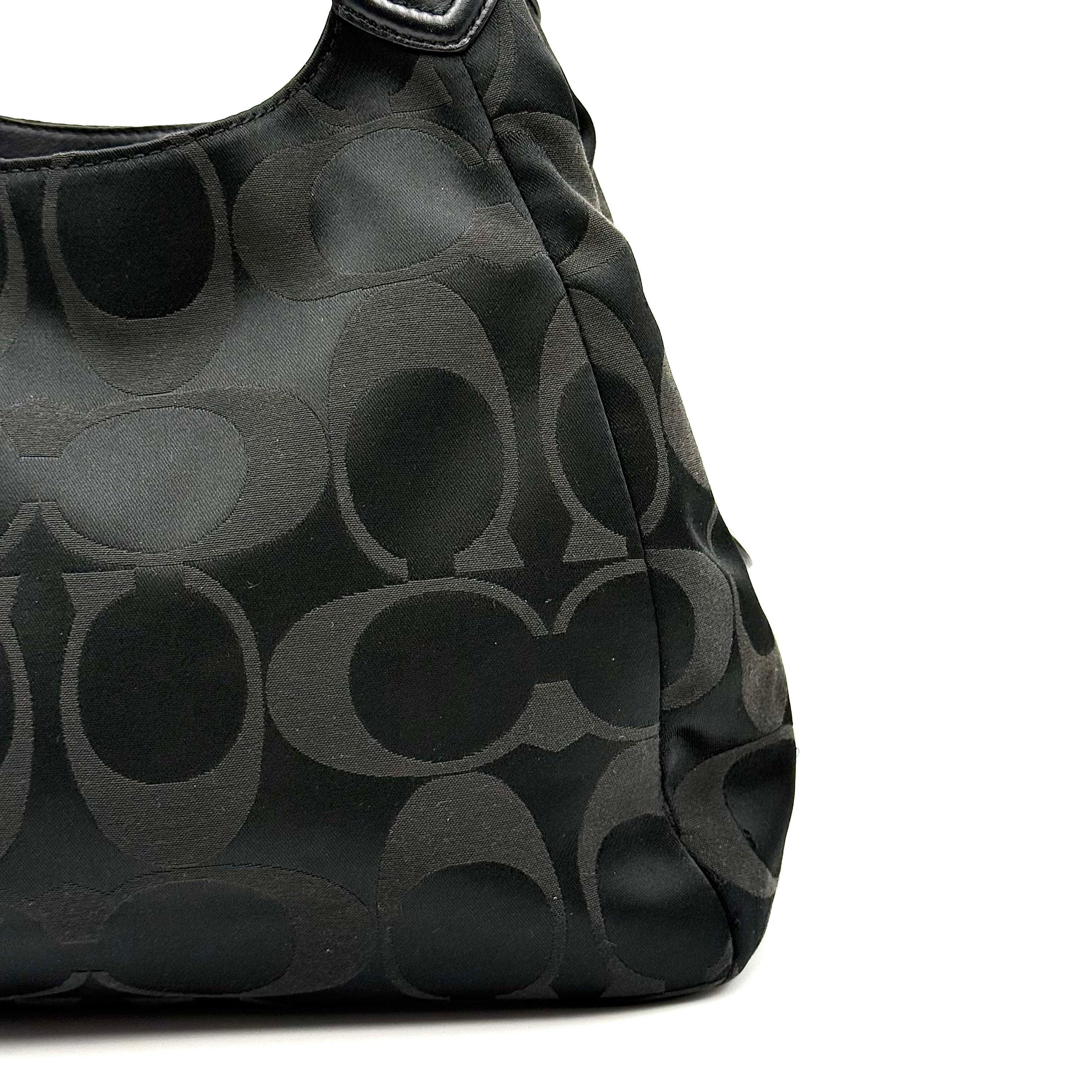 Coach Signature Campbell Hobo Shoulder Bag in black jacquard canvas with leather trim and front buckle pocket, photographed against a white background.