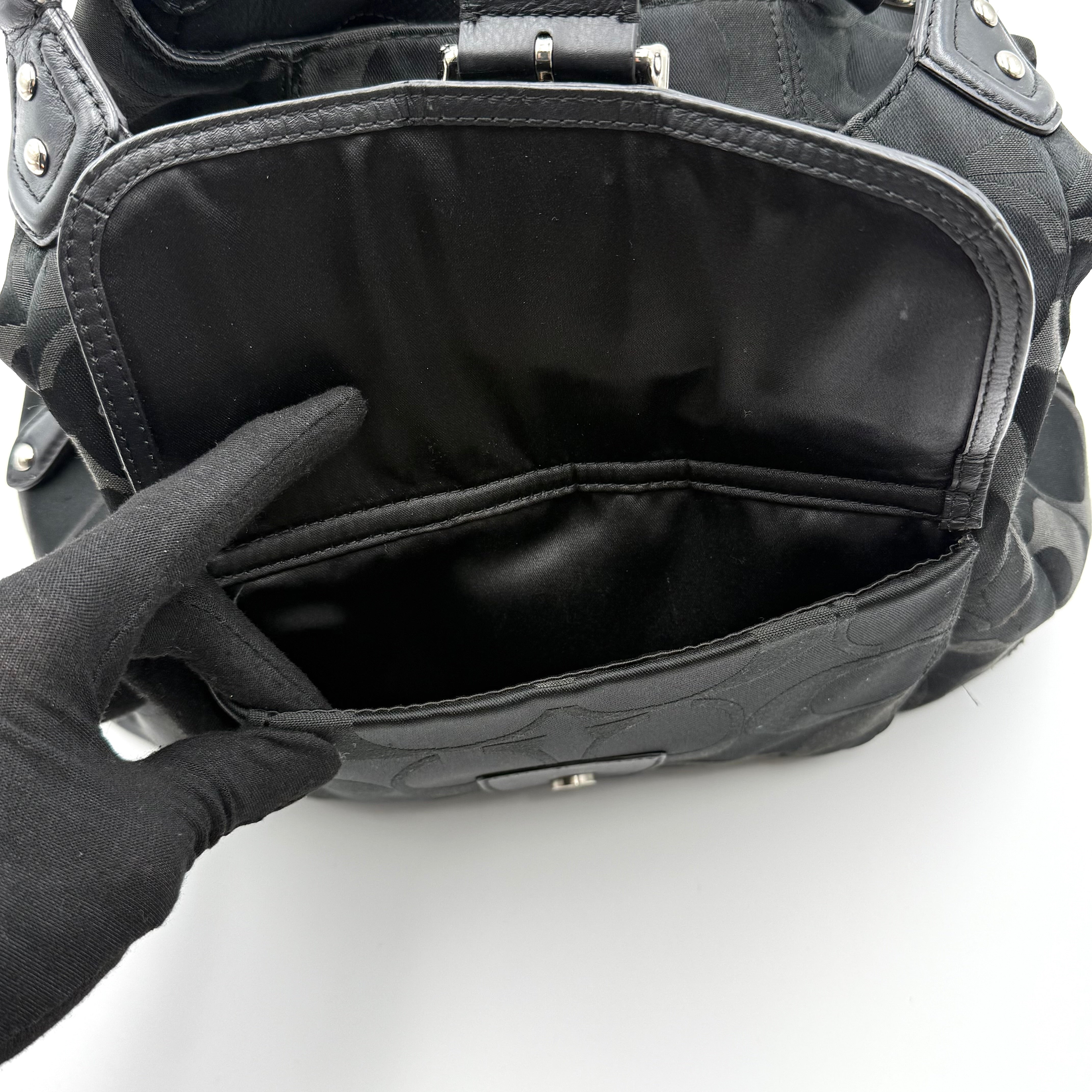 Coach Signature Campbell Hobo Shoulder Bag in black jacquard canvas with leather trim and front buckle pocket, photographed against a white background.