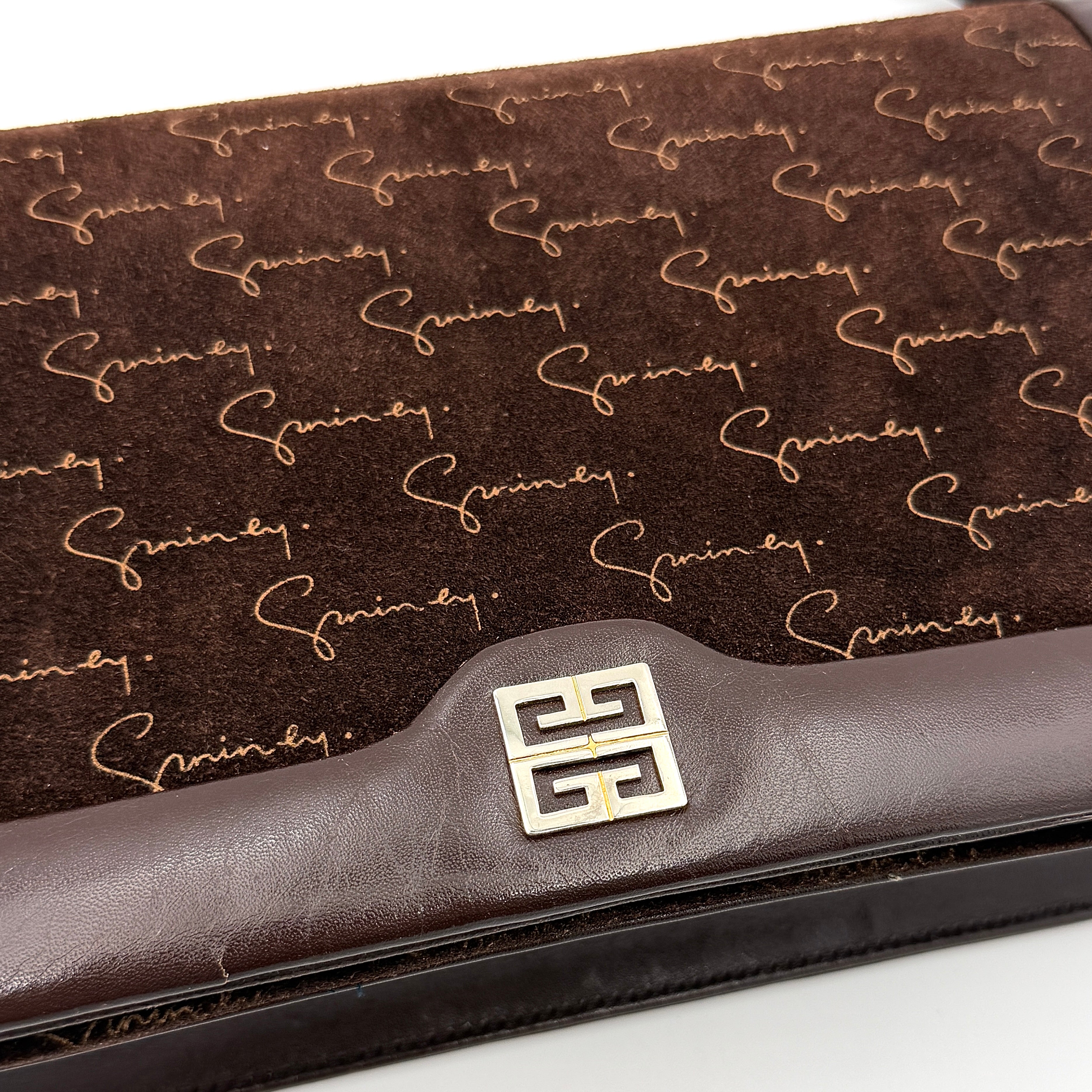 Givenchy 4G Monogram brown suede shoulder bag with leather trim and silver-tone clasp, photographed on a white background.