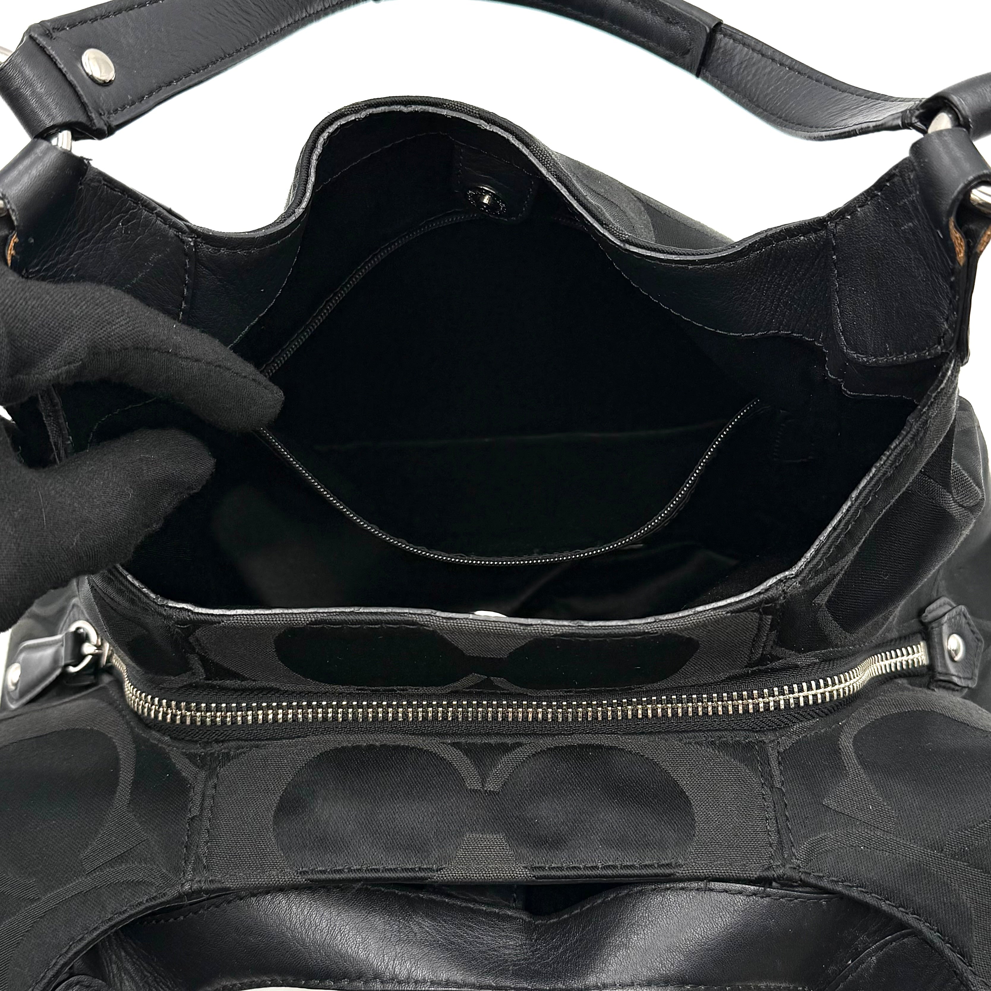 Coach Signature Campbell Hobo Shoulder Bag in black jacquard canvas with leather trim and front buckle pocket, photographed against a white background.