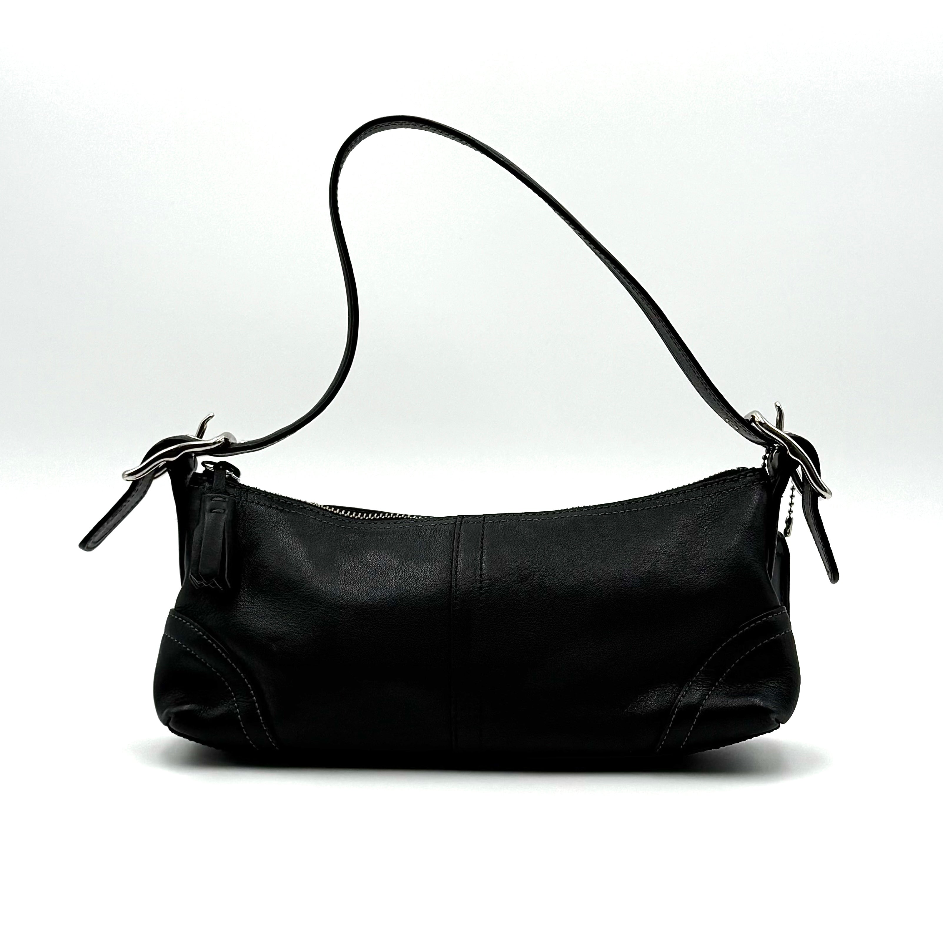 Coach Hampton Demi Baguette shoulder bag in smooth black leather with a curved top handle and silver-tone hardware.