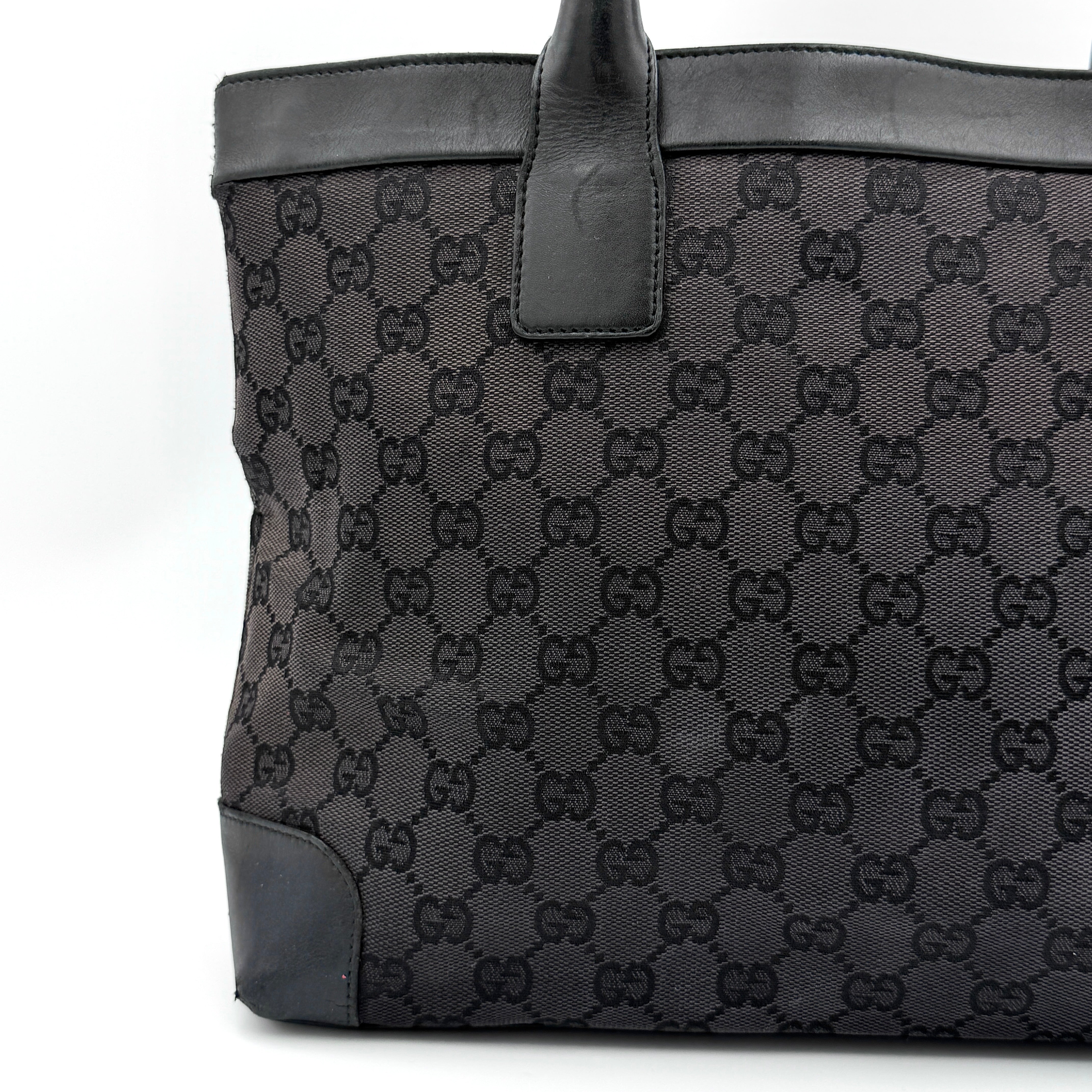 Gucci GG Monogram Leather Tote Bag in black canvas and leather, with structured top handles and allover GG motif.