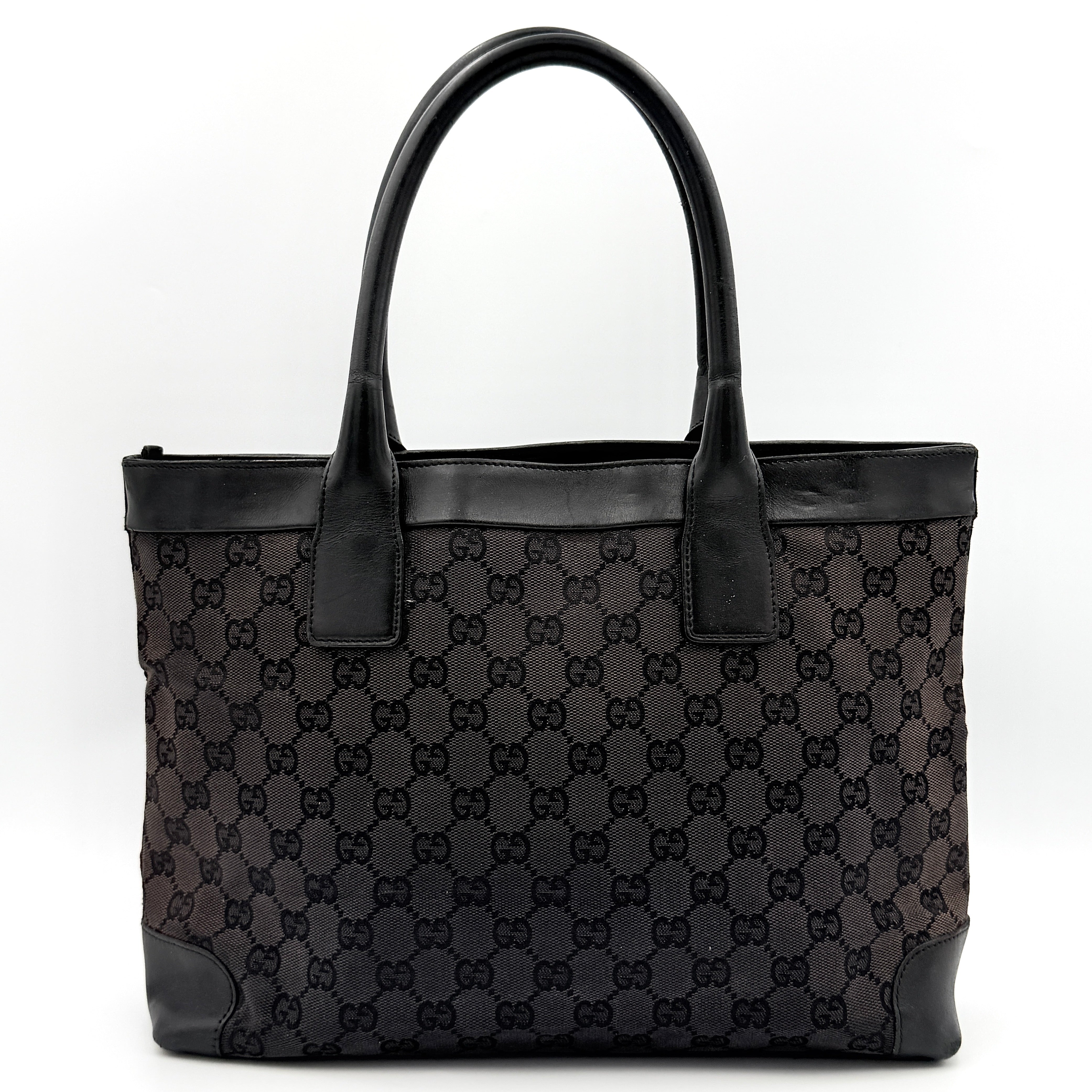 Gucci GG Monogram Leather Tote Bag in black canvas and leather, with structured top handles and allover GG motif.