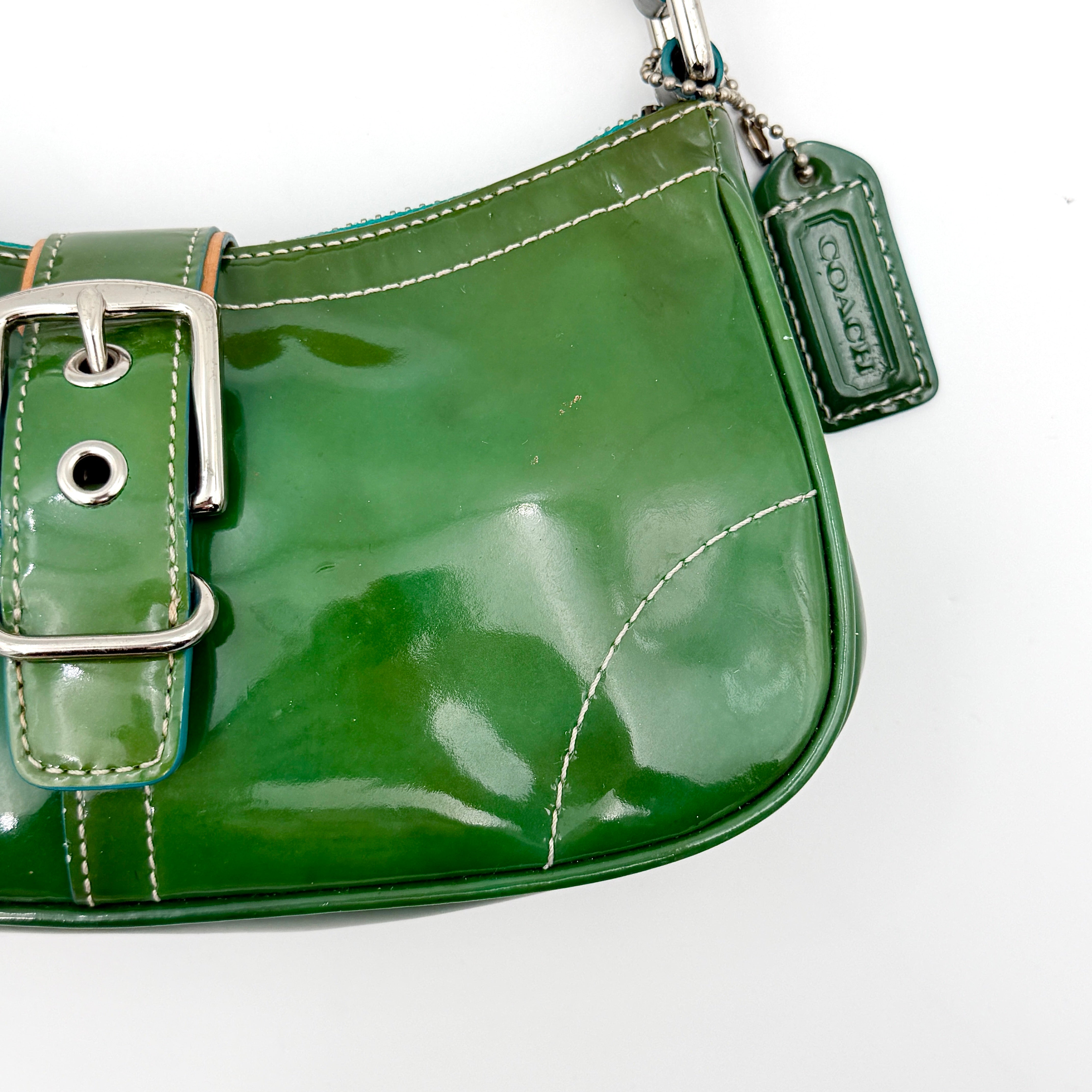 Coach Y2K Demi Soho shoulder bag in glossy green patent leather with silver hardware and natural leather strap.