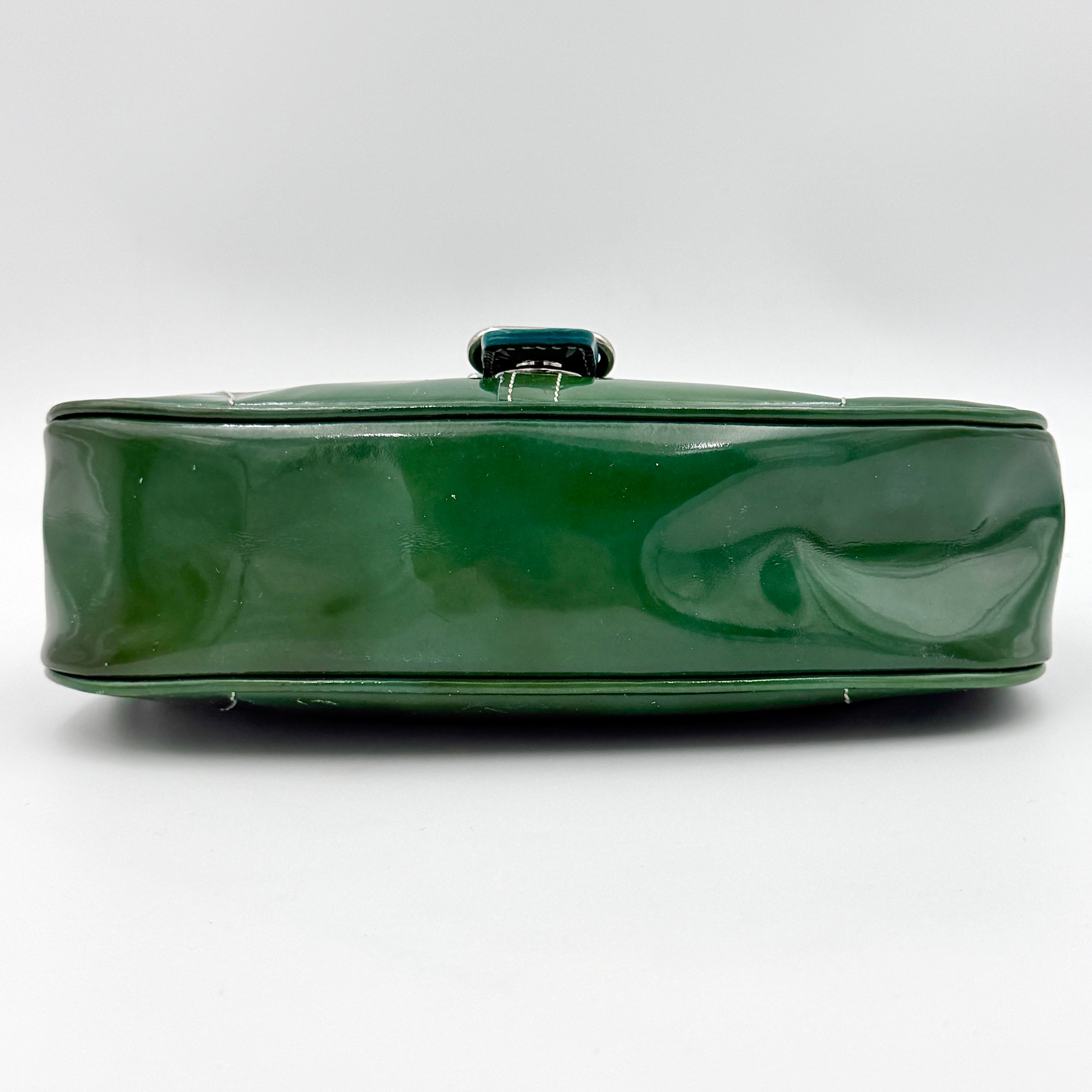 Coach Y2K Demi Soho shoulder bag in glossy green patent leather with silver hardware and natural leather strap.