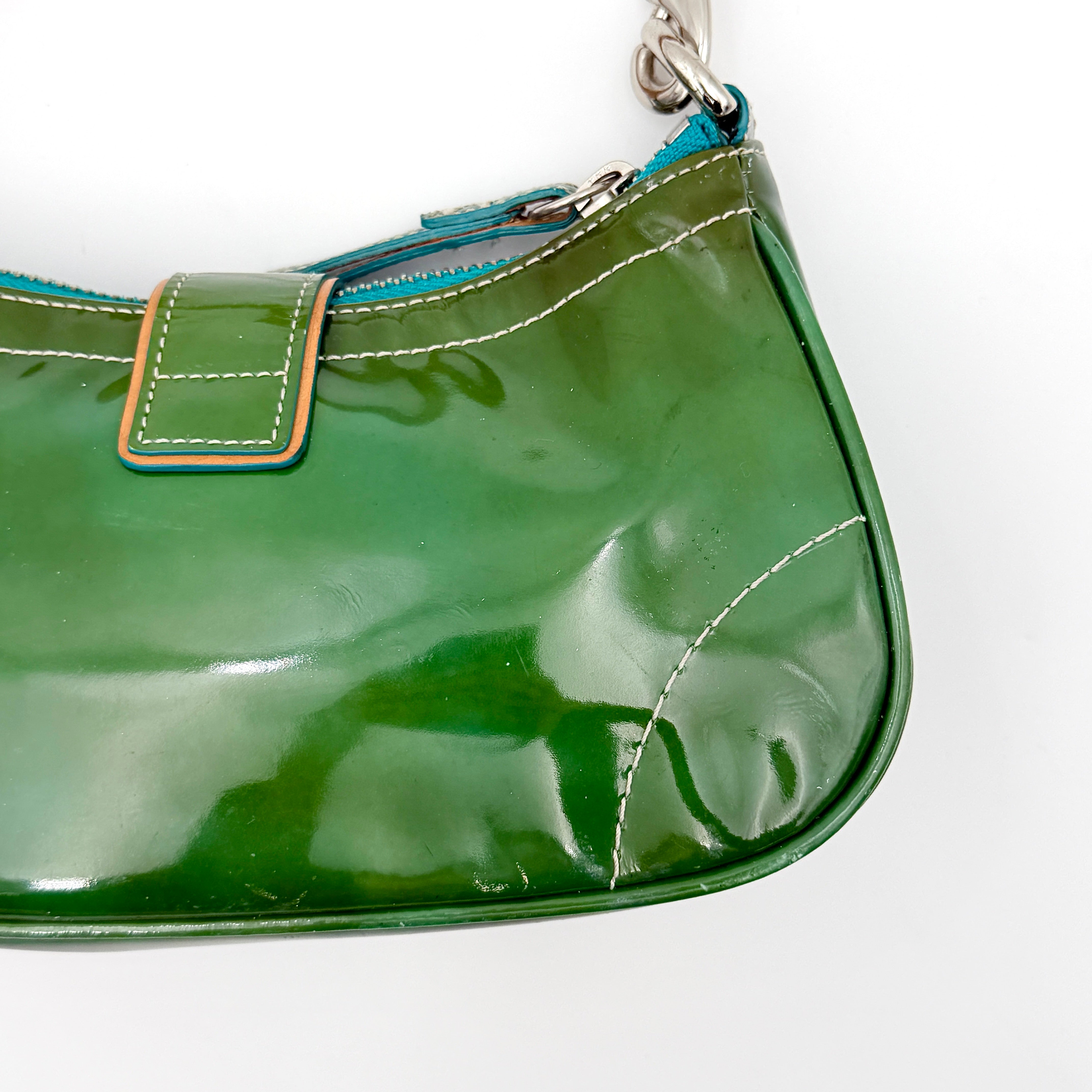 Coach Y2K Demi Soho shoulder bag in glossy green patent leather with silver hardware and natural leather strap.