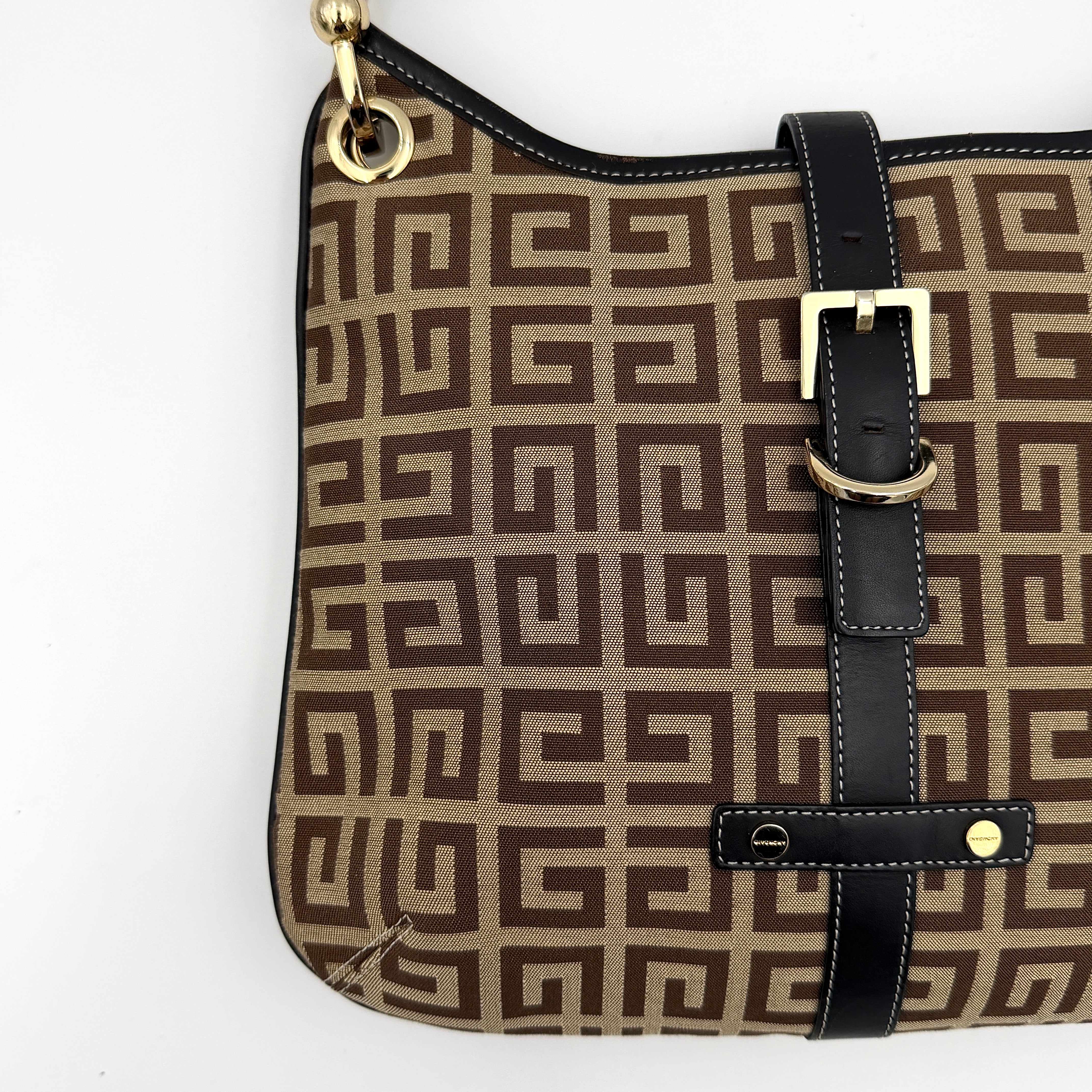 The Givenchy Monogram Hobo Shoulder Bag in brown canvas with black leather trim and gold hardware, displayed front-facing.