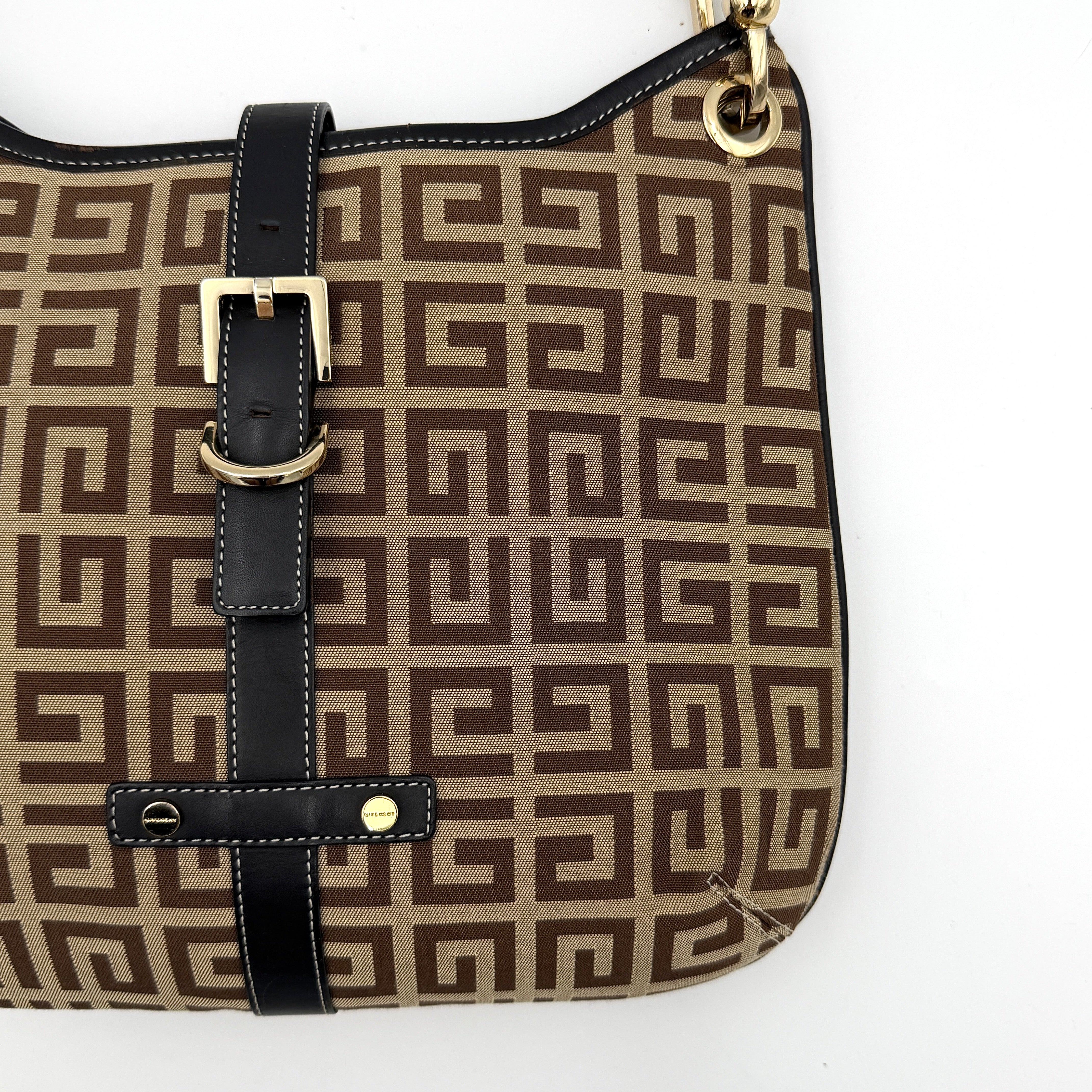 The Givenchy Monogram Hobo Shoulder Bag in brown canvas with black leather trim and gold hardware, displayed front-facing.