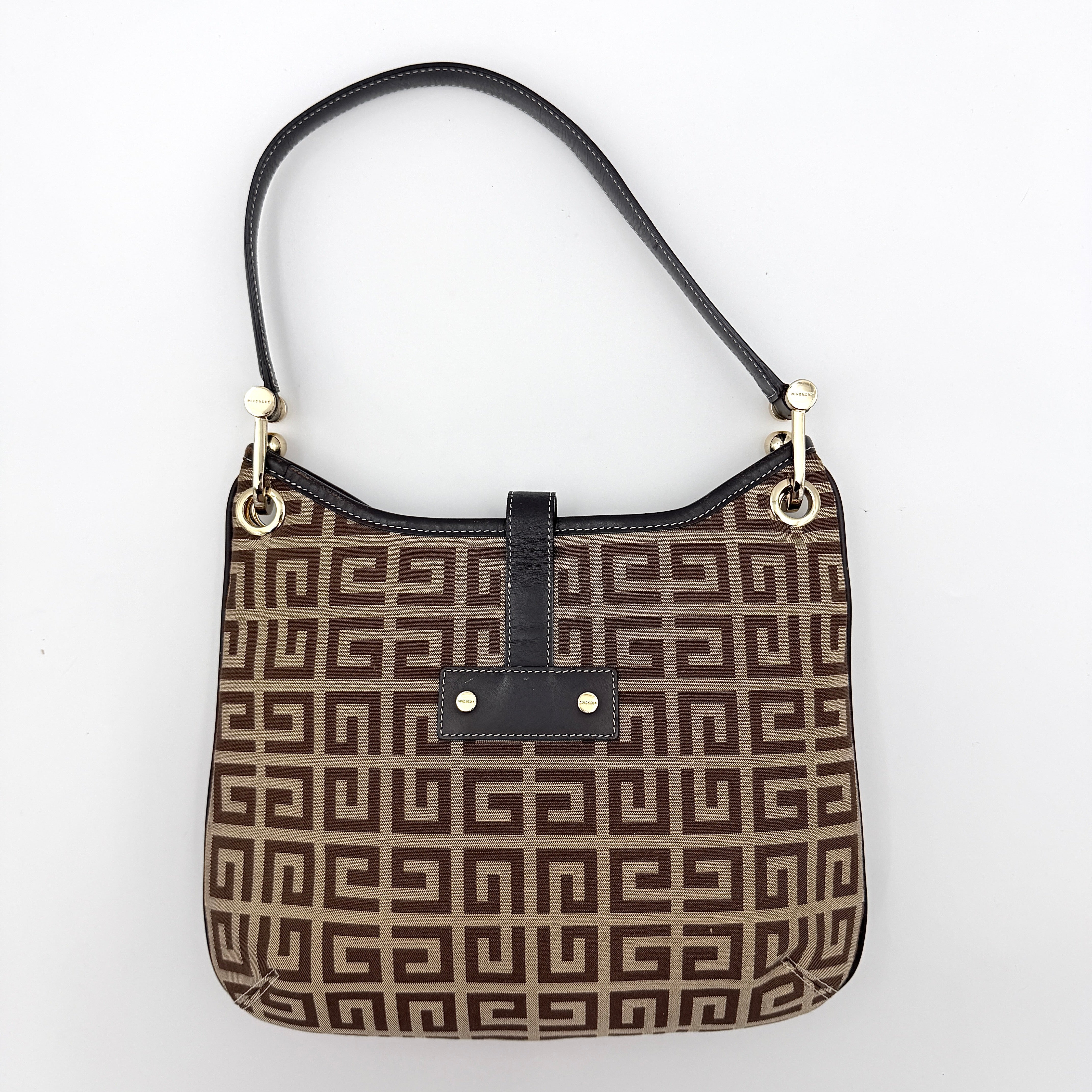 The Givenchy Monogram Hobo Shoulder Bag in brown canvas with black leather trim and gold hardware, displayed front-facing.