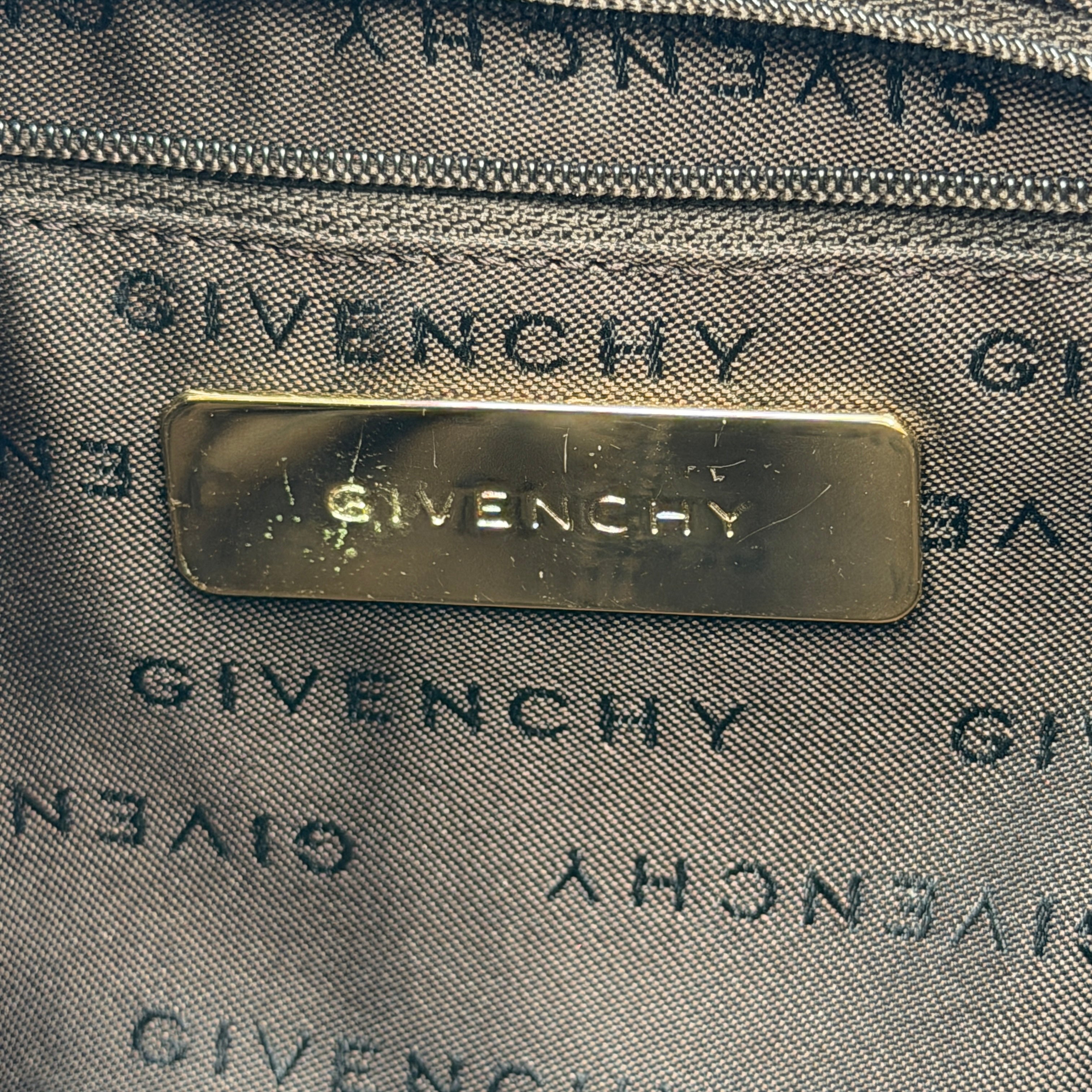 The Givenchy Monogram Hobo Shoulder Bag in brown canvas with black leather trim and gold hardware, displayed front-facing.