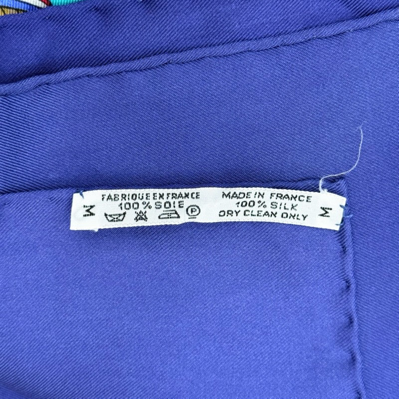 Hermès Liberté Égalité Fraternité silk scarf in vibrant blue with classical French motifs and tricolour accents.