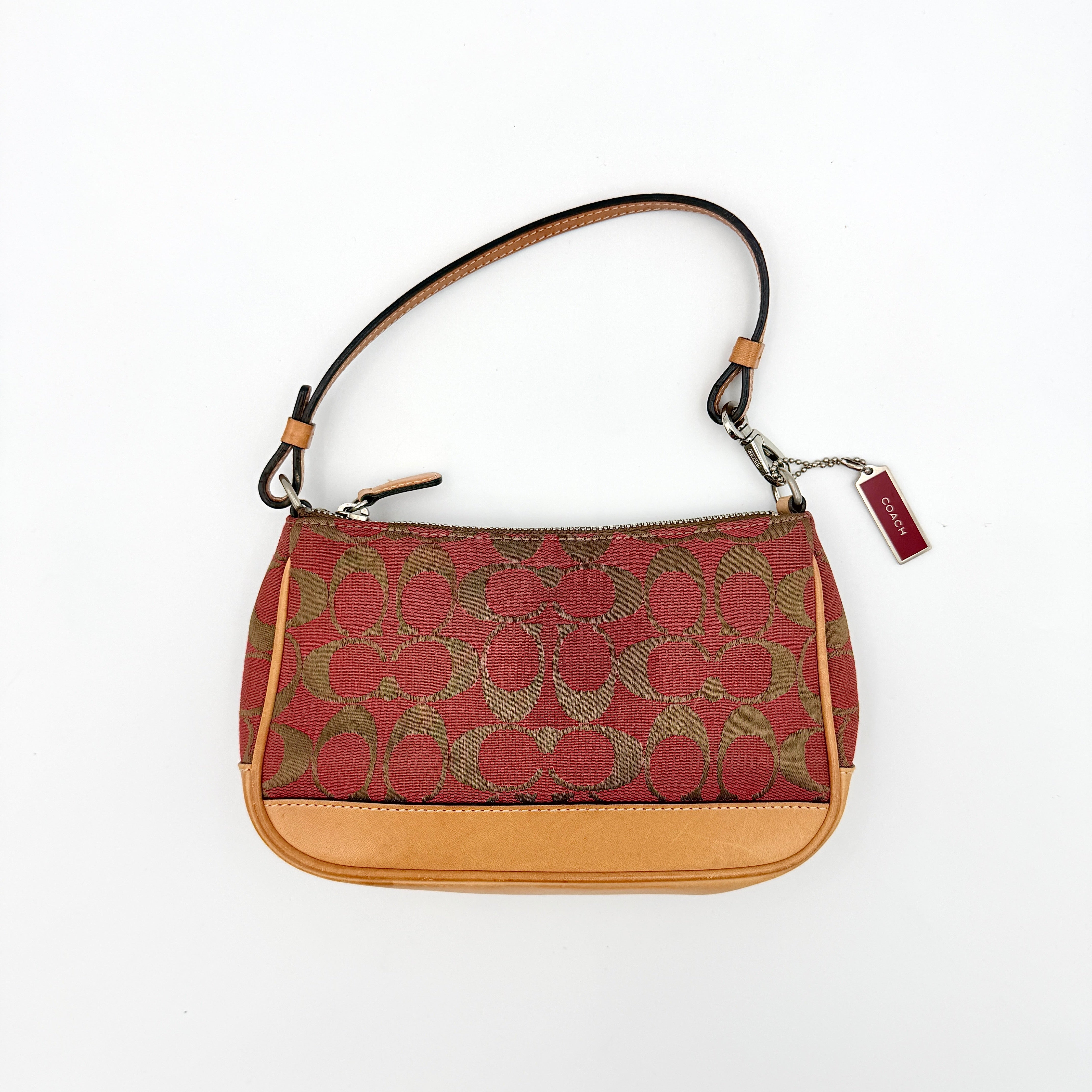 Coach Y2K Demi Shoulder Bag in red and tan signature monogram with leather trim, shown with leather strap and Coach tag.