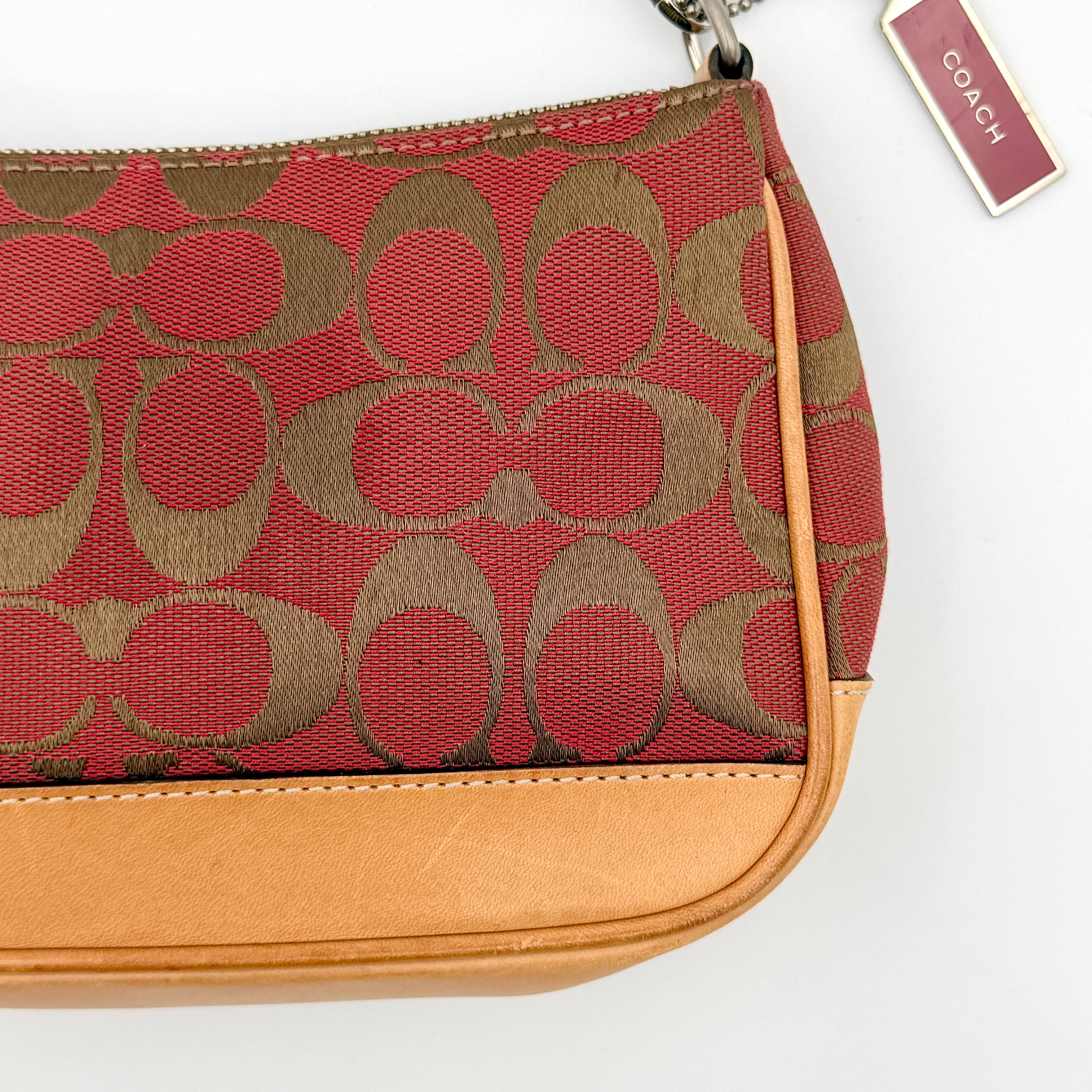 Coach Y2K Demi Shoulder Bag in red and tan signature monogram with leather trim, shown with leather strap and Coach tag.