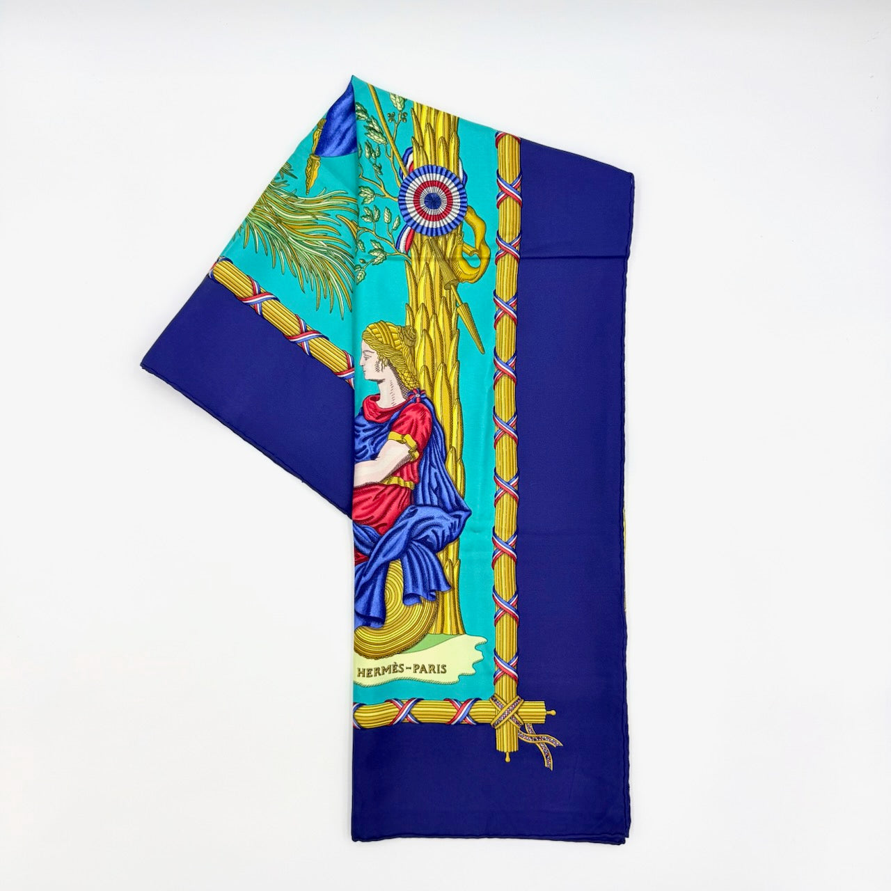 Hermès Liberté Égalité Fraternité silk scarf in vibrant blue with classical French motifs and tricolour accents.