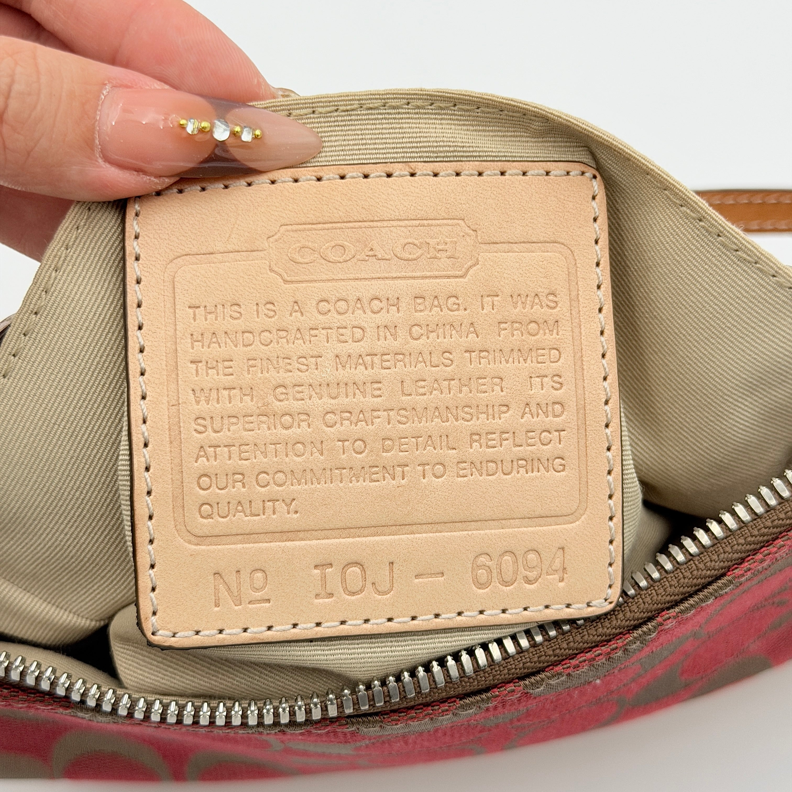 Coach Y2K Demi Shoulder Bag in red and tan signature monogram with leather trim, shown with leather strap and Coach tag.