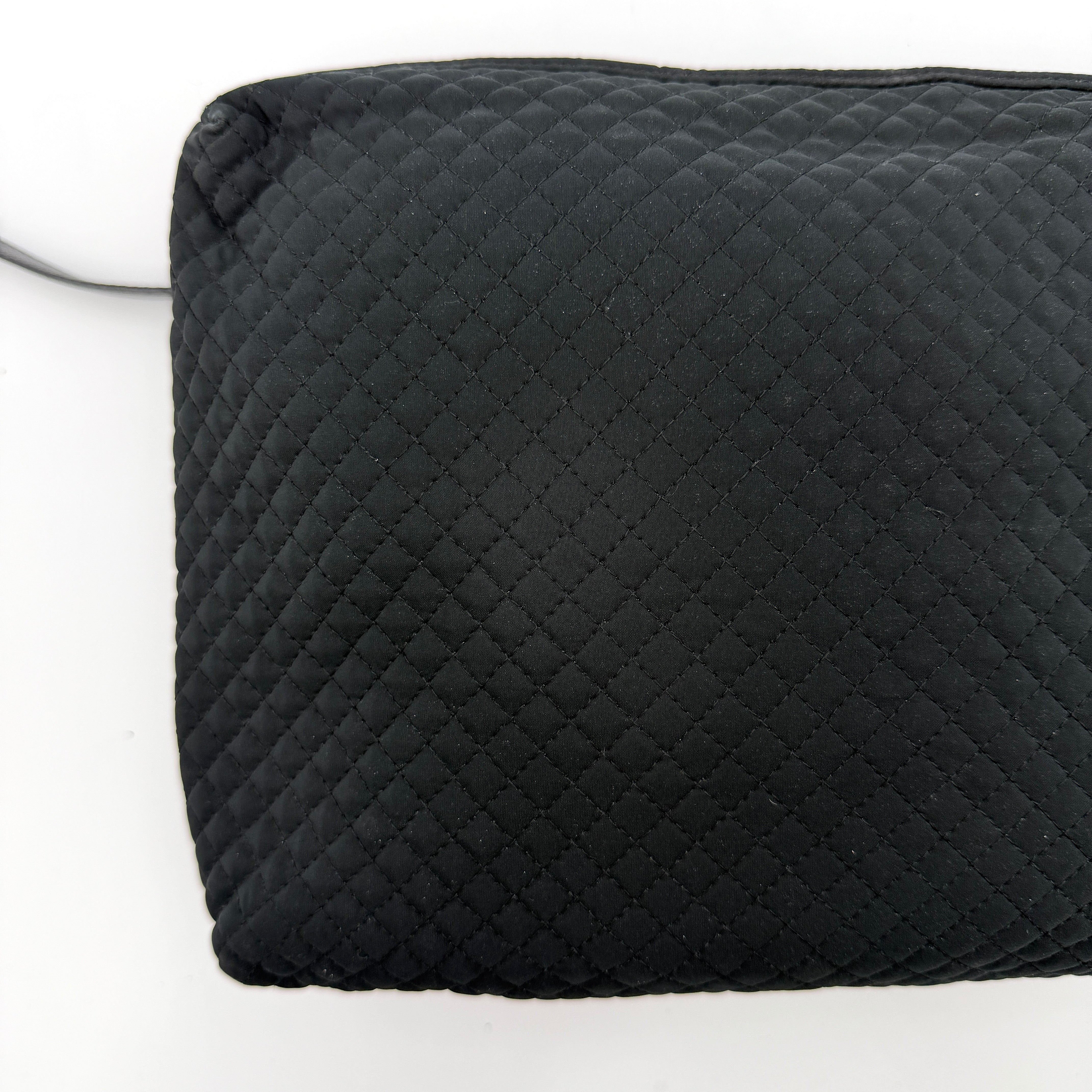 Bottega Veneta black quilted nylon crossbody bag with silver-tone logo hardware and leather strap.