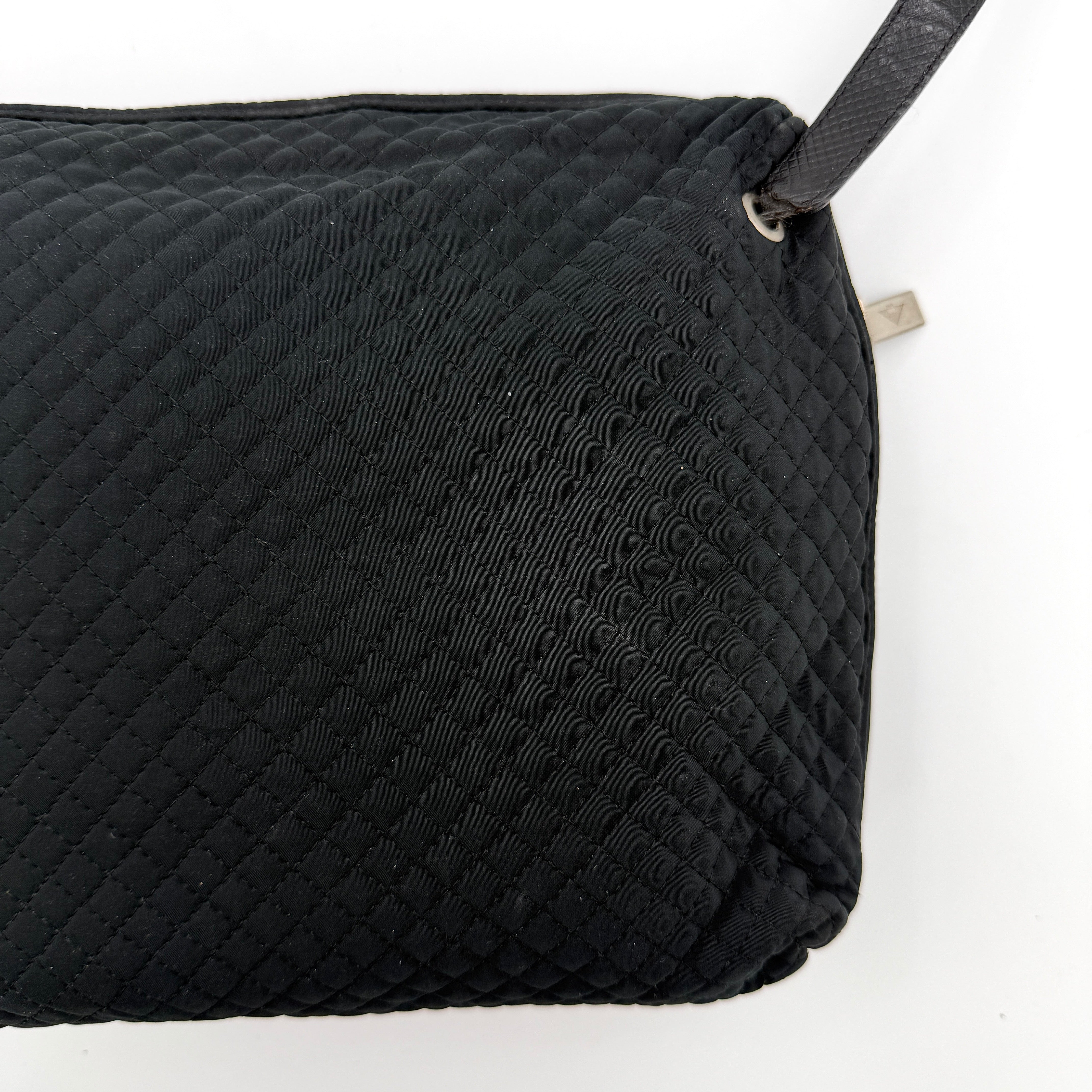 Bottega Veneta black quilted nylon crossbody bag with silver-tone logo hardware and leather strap.