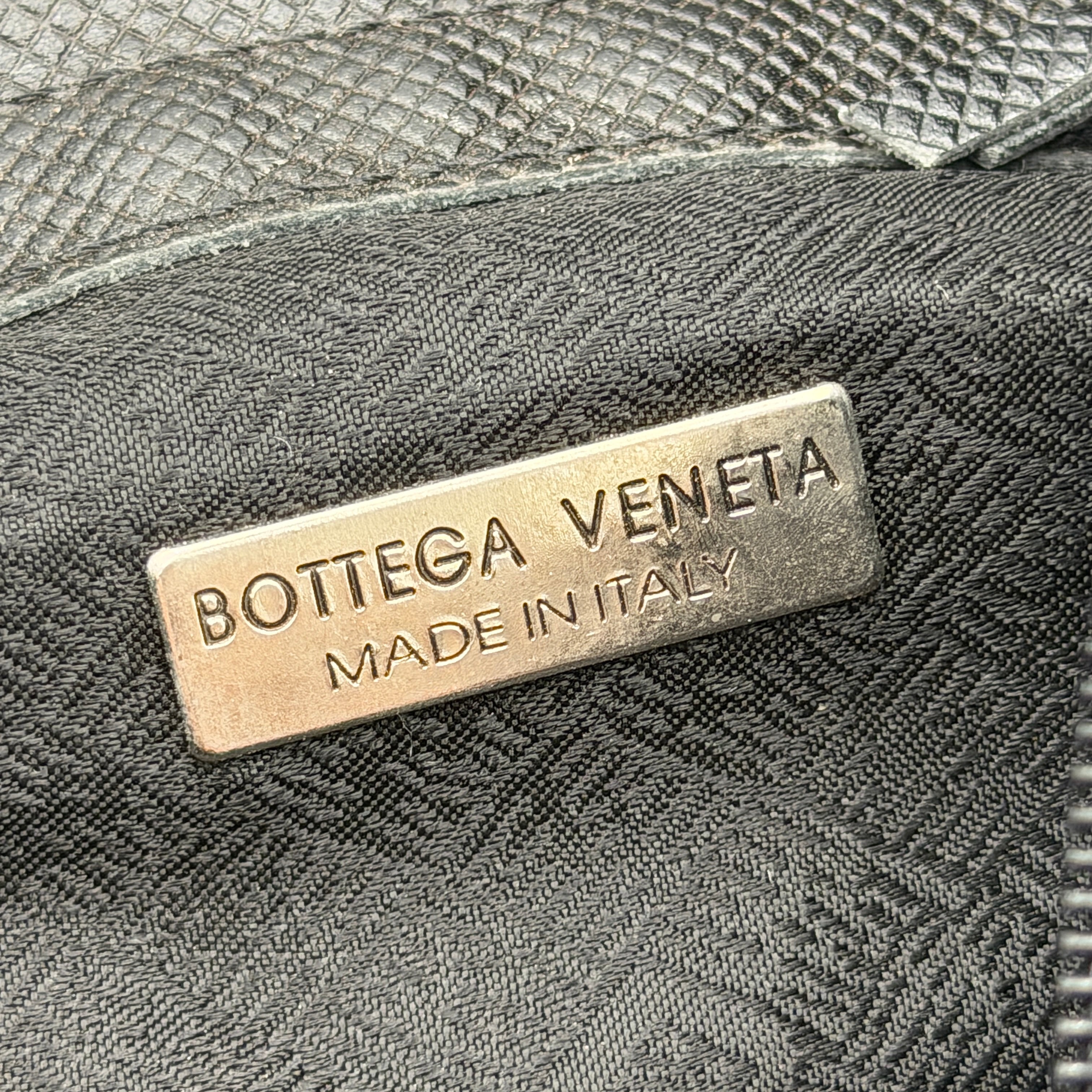 Bottega Veneta black quilted nylon crossbody bag with silver-tone logo hardware and leather strap.