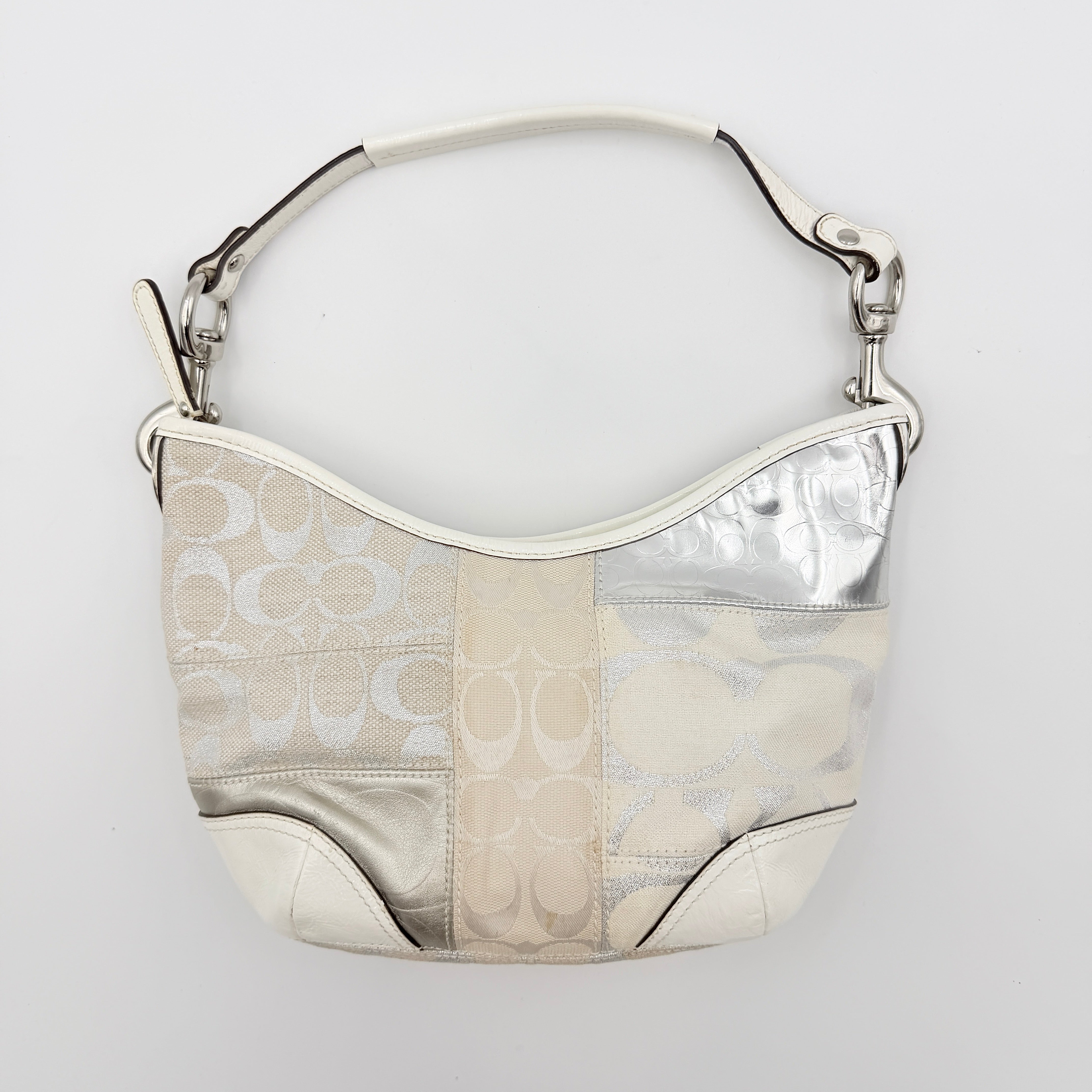 Coach Y2K Signature Patchwork Hobo Shoulder Bag in cream and silver jacquard with wide leather handle, shown on a white background.