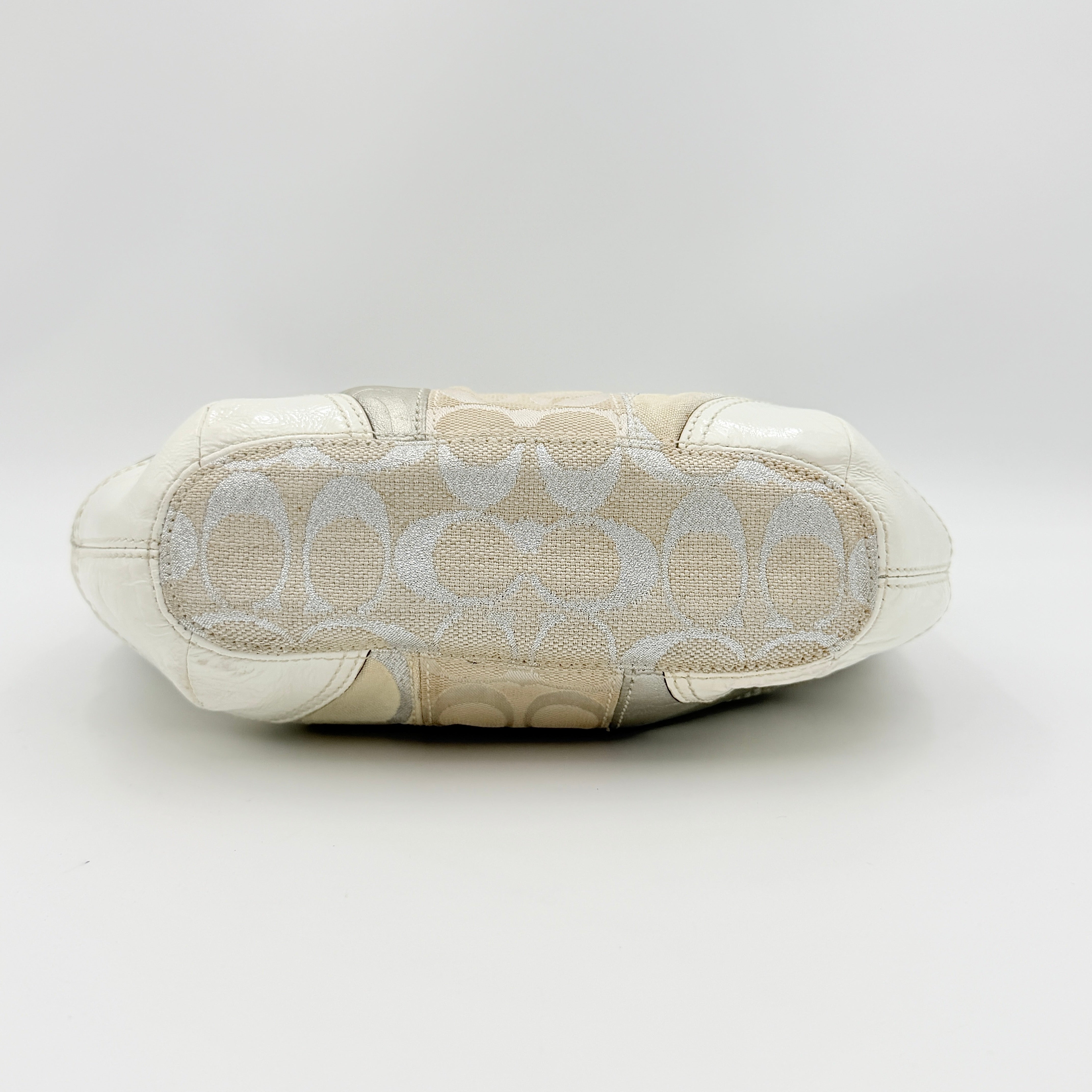 Coach Y2K Signature Patchwork Hobo Shoulder Bag in cream and silver jacquard with wide leather handle, shown on a white background.